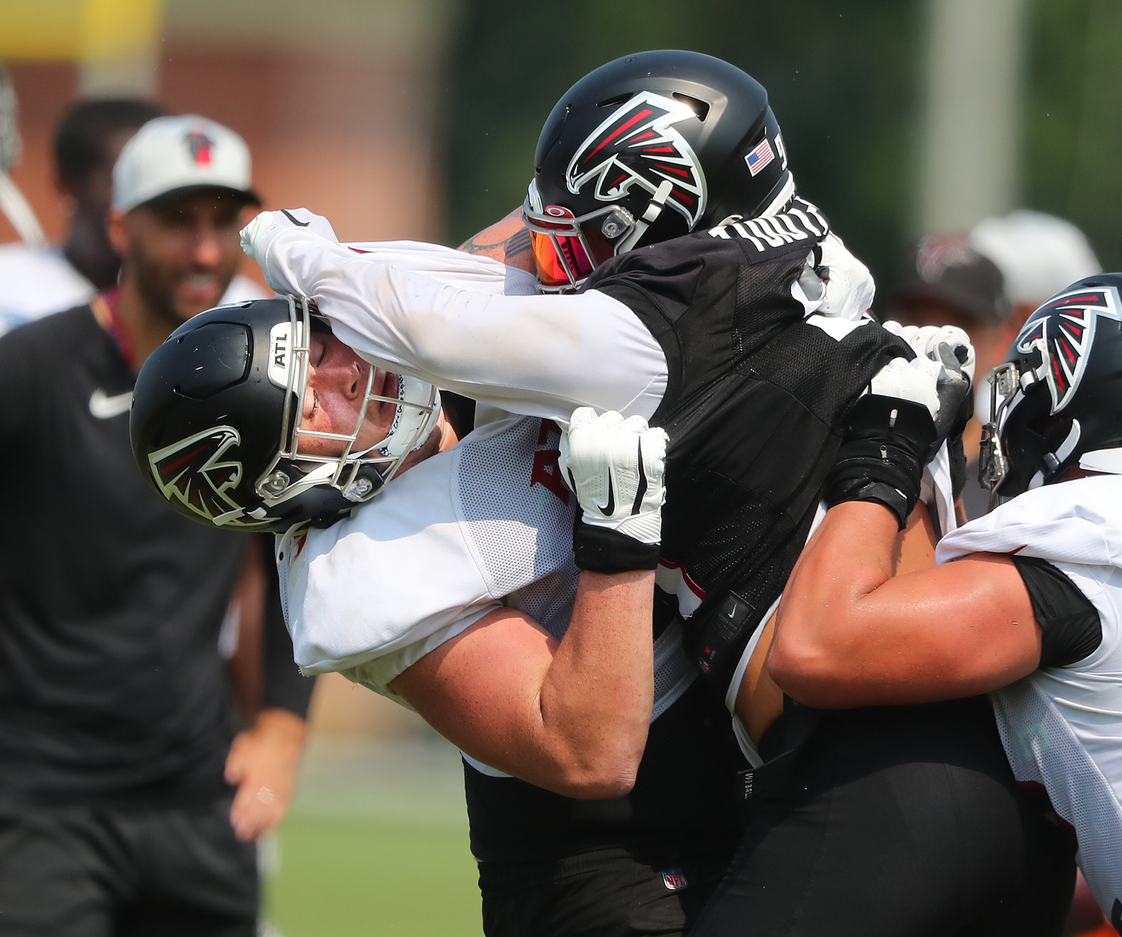 Atlanta Falcons outside linebacker Jacob Tuioti-Mariner (right) levels rookie offensive lineman Jalen Mayfield at the line of scrimmage on the third day of training camp practice on Saturday, July 31, 2021, in Flowery Branch. “Curtis Compton / Curtis.Compton@ajc.com”