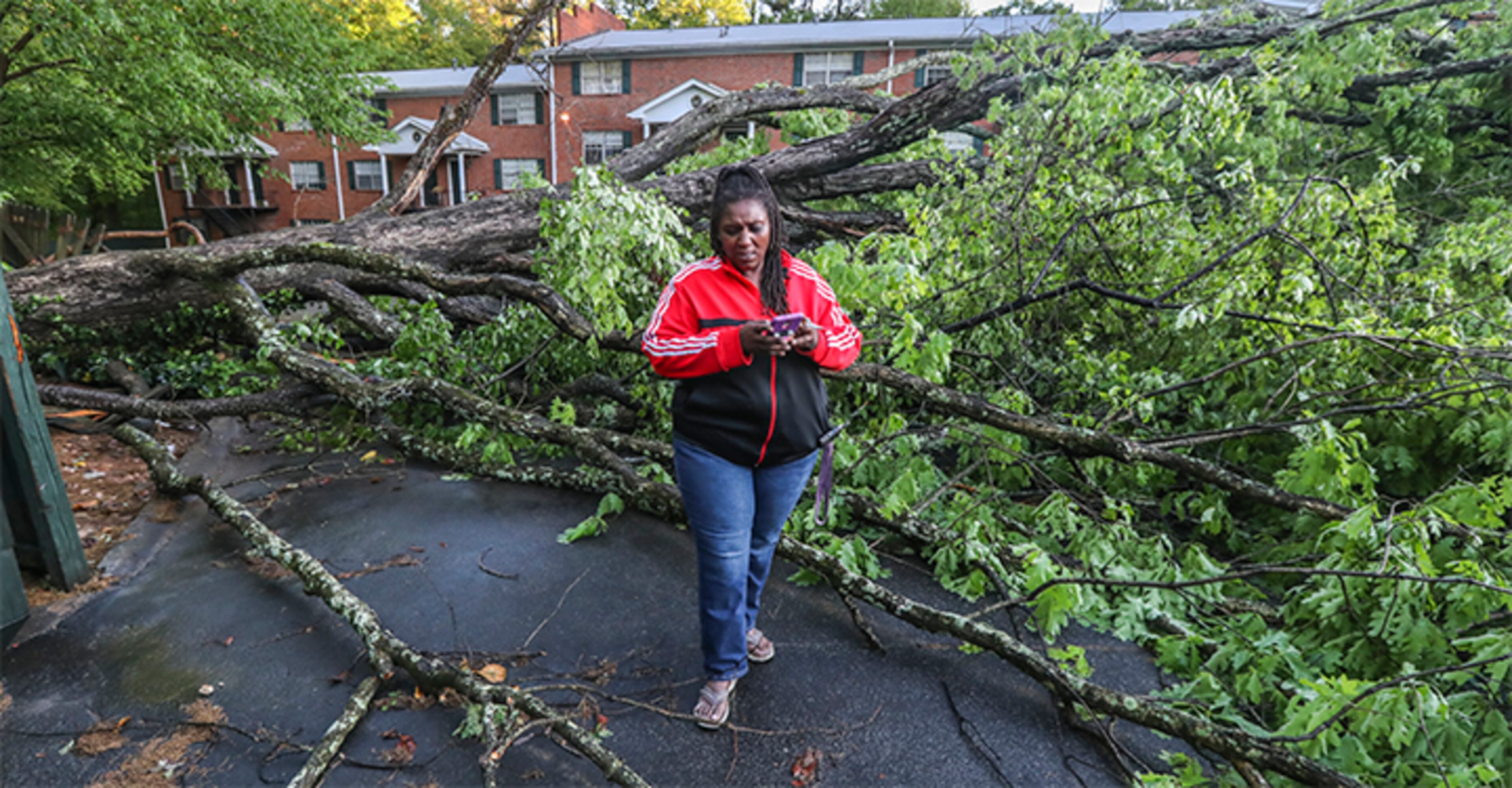 April 13, 2020 East Point: Monique Best took pictures with her phone of her car buried under a tree that fell in the Lexington Apartments where she lives on Monday, April 13, 2020 after overnight storms blew through East Point. Best drives as an Uber driver for a living. Cleanup and damage assessment are underway Monday after powerful storms ripped through North Georgia overnight, killing at least six people in the state and leaving thousands in the dark. Cleanup and damage assessment are underway Monday after powerful storms ripped through North Georgia overnight, killing at least six people in the state and leaving thousands in the dark. The widespread storms produced possible tornadoes in Chattooga County in northwest Georgia and south Fulton County in metro Atlanta, as well as Putnam and Upson counties to the south. The National Weather Service is still working to confirm those reports and identify storm tracks. JOHN SPINK/JSPINK@AJC.COM
