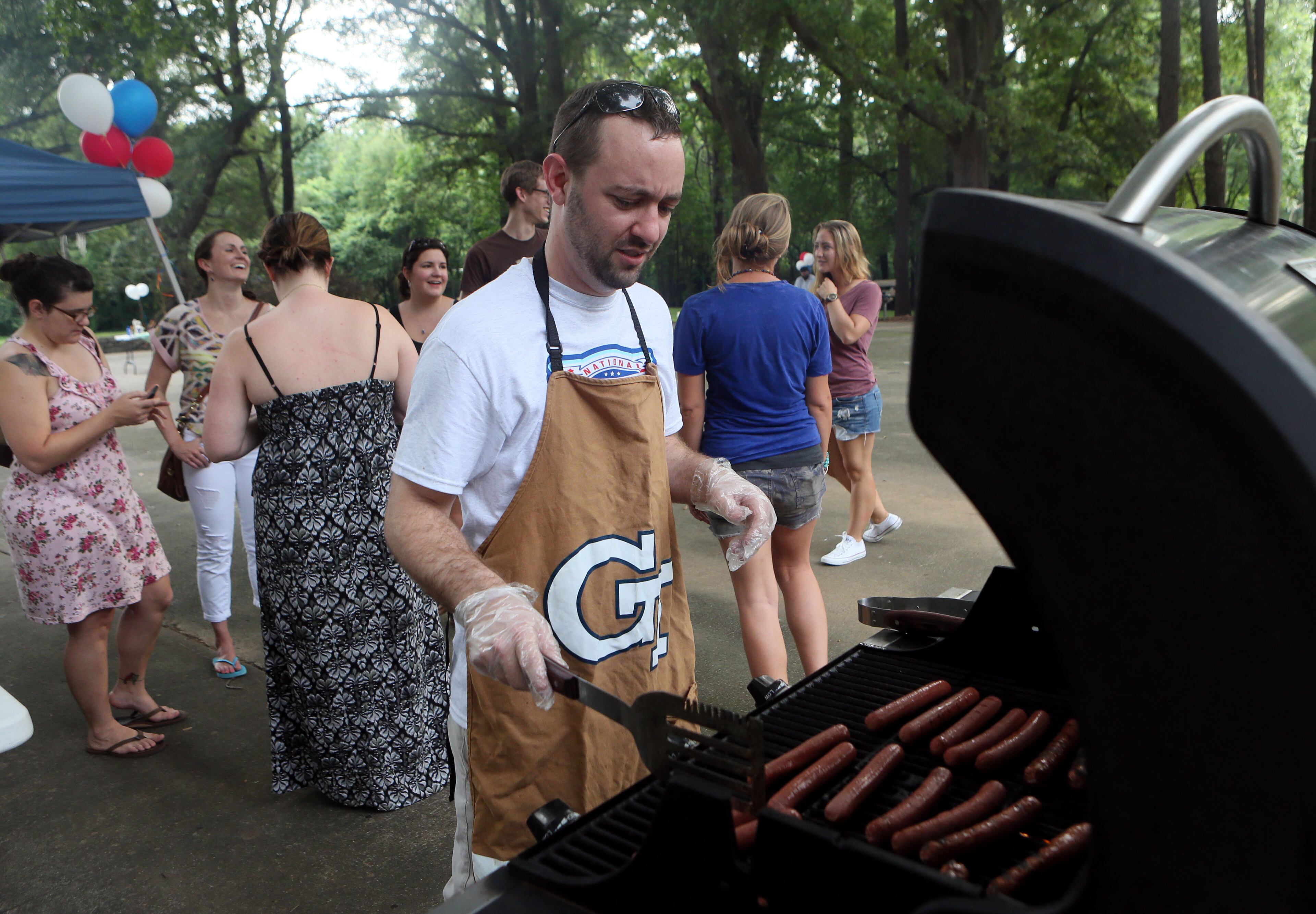Eric Schwartz manned the grill at the Parkview Community Recreational Center in Atlanta during the 30th anniversary of National Night Out on Tuesday. The event featured a neighborhood parade, DJ dance party, free food & back-to-school giveaways.