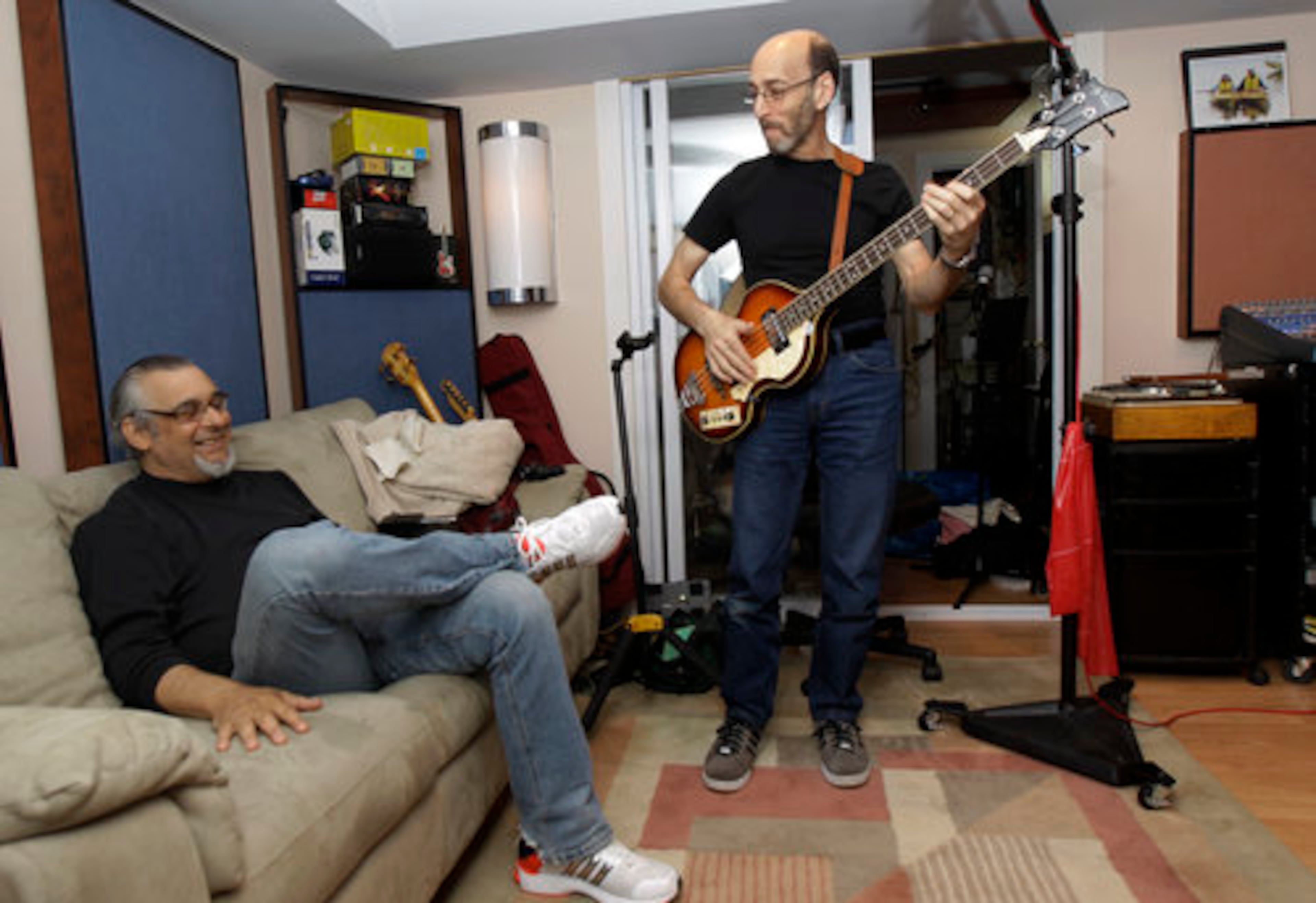 Musicians Larry Gates, right, and Lee Shapiro talk inside Gates' studio in Fair Lawn, N.J. The two are part of the Four Seasons band, which hase been rehearsing in Gates' basement in preparation for a nationwide tour.