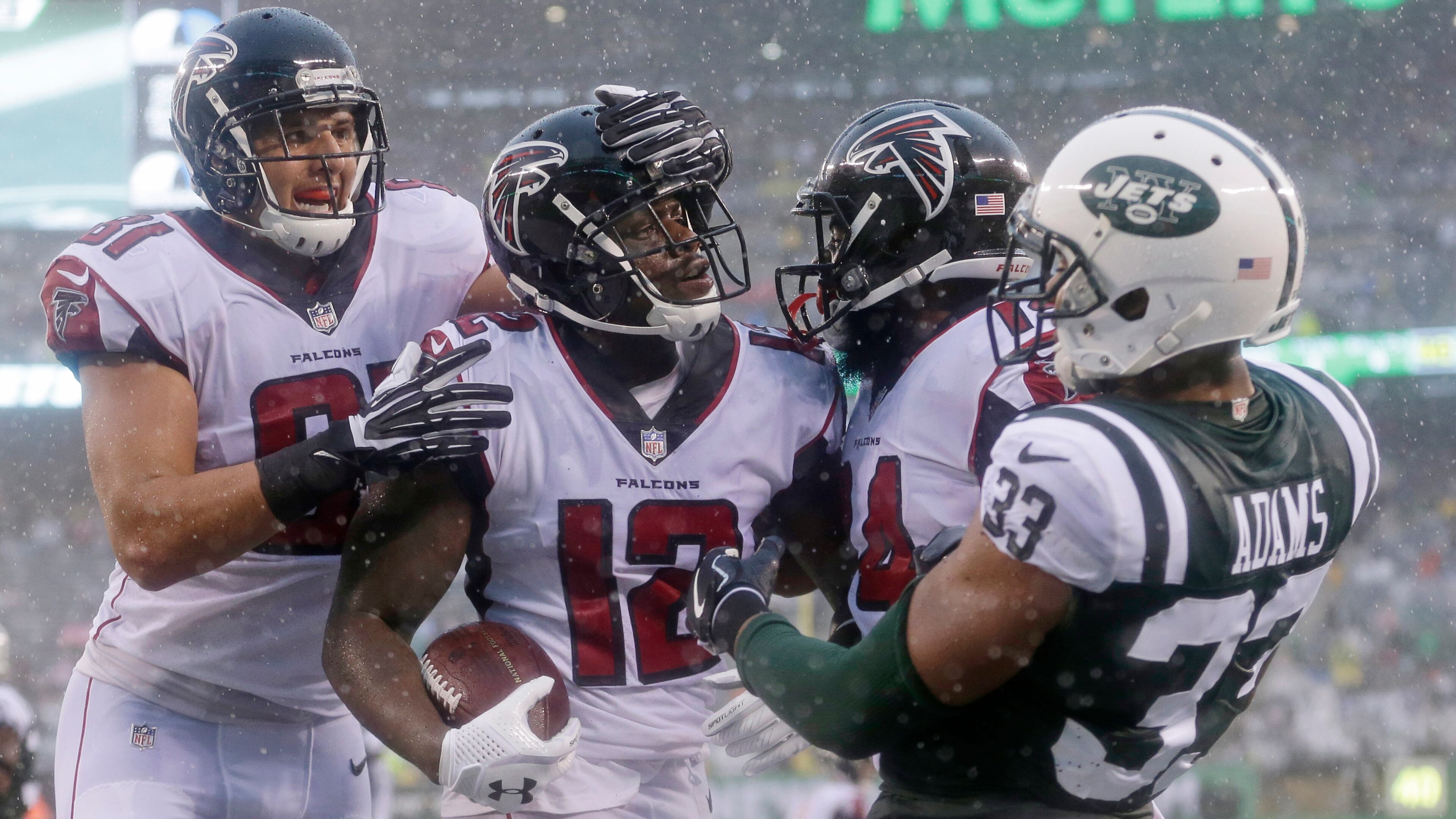 Atlanta Falcons wide receiver Mohamed Sanu (12) exchanges words with New York Jets' Jamal Adams (33) after catching a pass for a touchdown during the second half of an NFL football game Sunday, Oct. 29, 2017, in East Rutherford, N.J. (AP Photo/Seth Wenig)