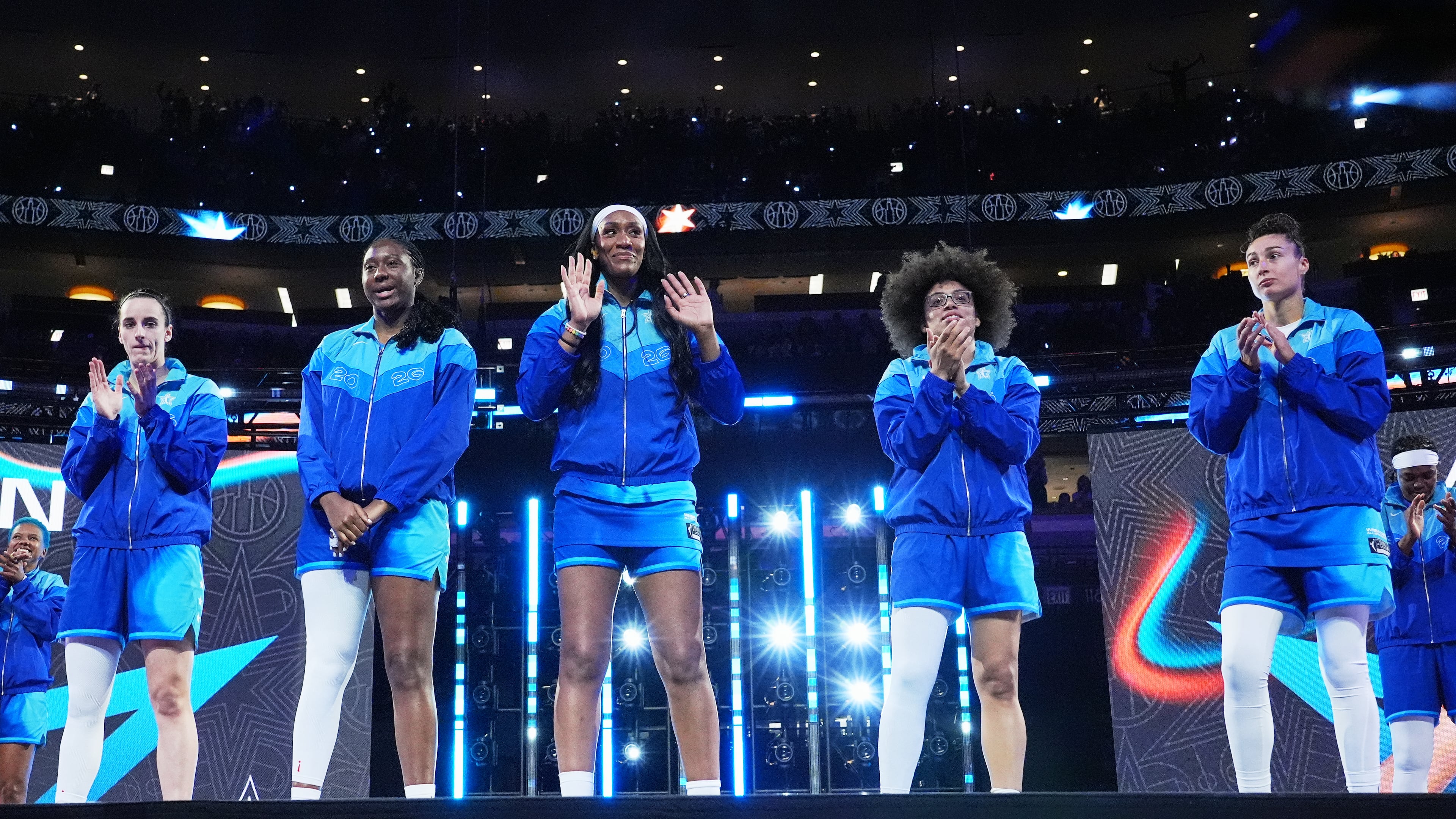 Left to right; Team Spoon's Caitlin Clark, Aliyah Boston, A'Ja Wilson, Olivia Miles and Jessica Shepard greet fans before a WNBA All-Star basketball game against Team Coop in Chicago, Saturday, July 25, 2026. (AP Photo/Nam Y. Huh)
