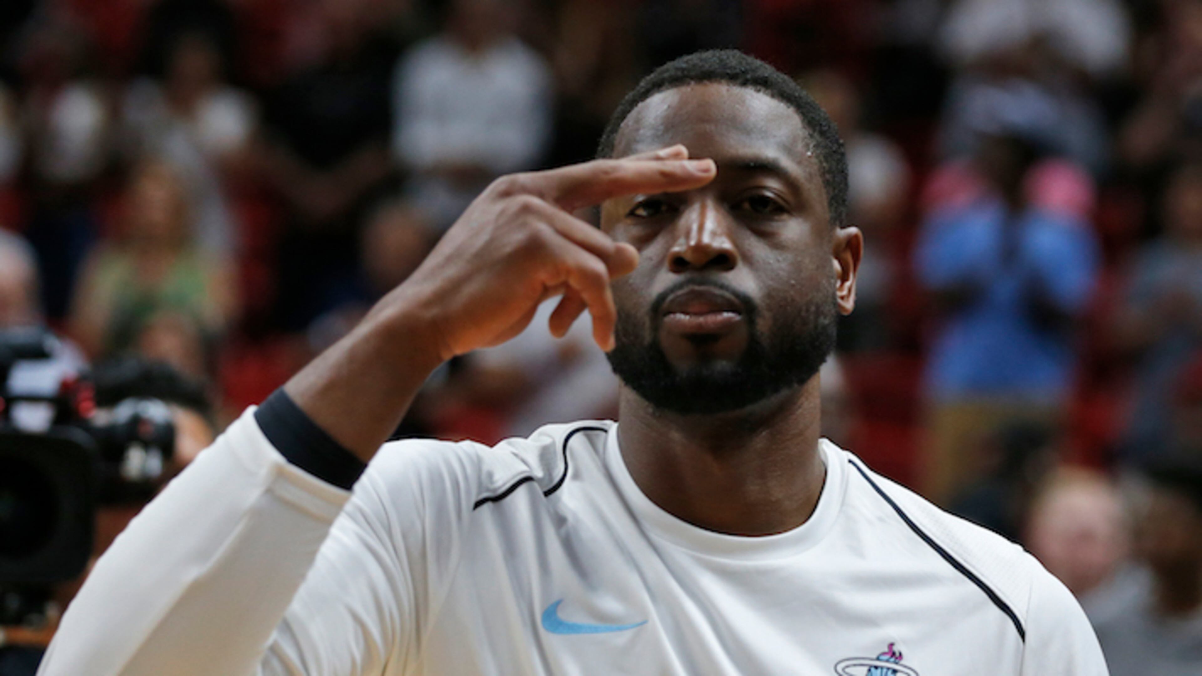 Miami Heat guard Dwyane Wade gestures after the singing of the National Anthem before the start of an NBA basketball game against the Los Angeles Lakers, Thursday, March 1, 2018, in Miami. (AP Photo/Wilfredo Lee)