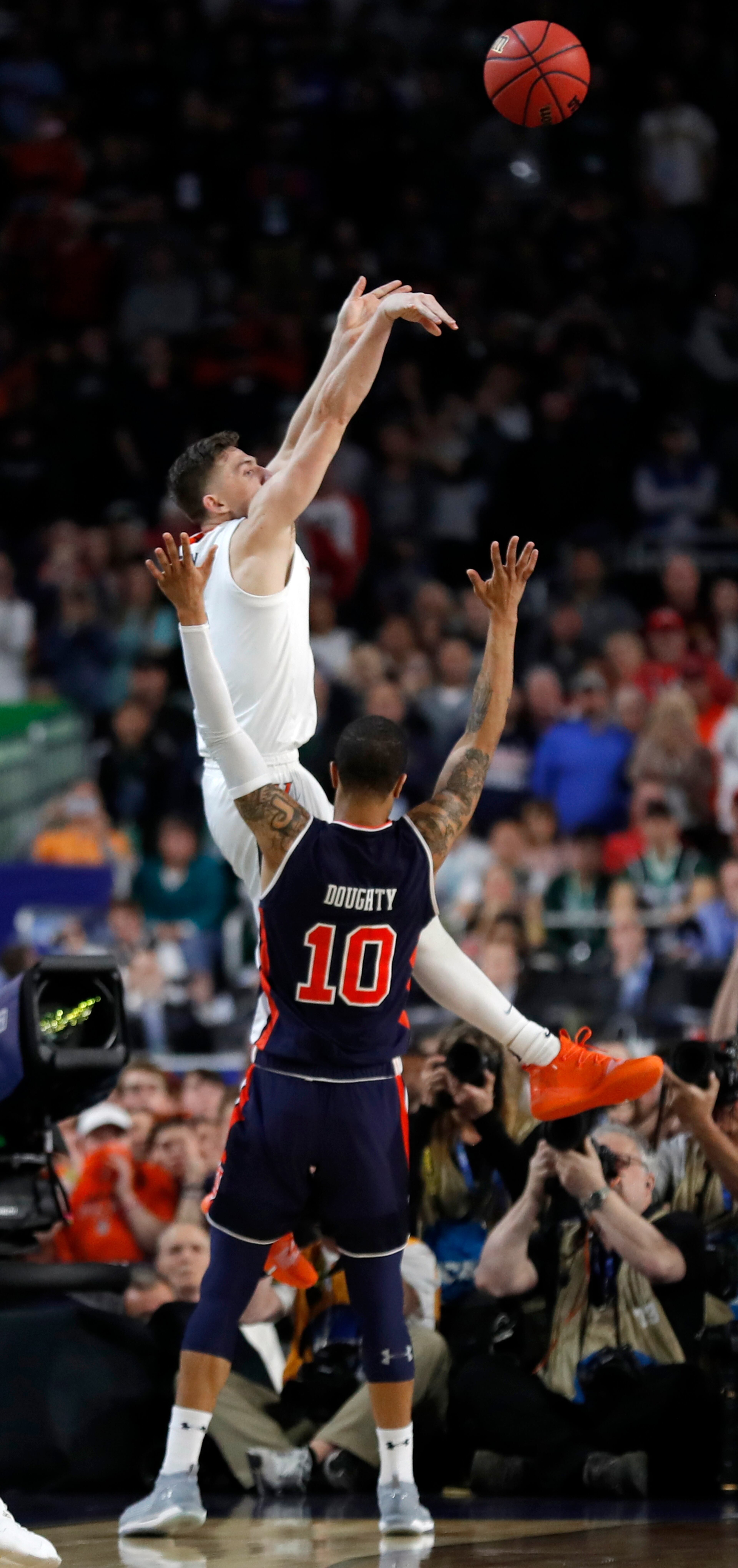 With his team down by two points, Kyle Guy of Virginia attempted a three-pointer as time expired. A foul was called on Auburn's Samir Doughty. Guy made all three free throws and the Cavs advanced to the national championship game. (AP Photo/Charlie Neibergall)