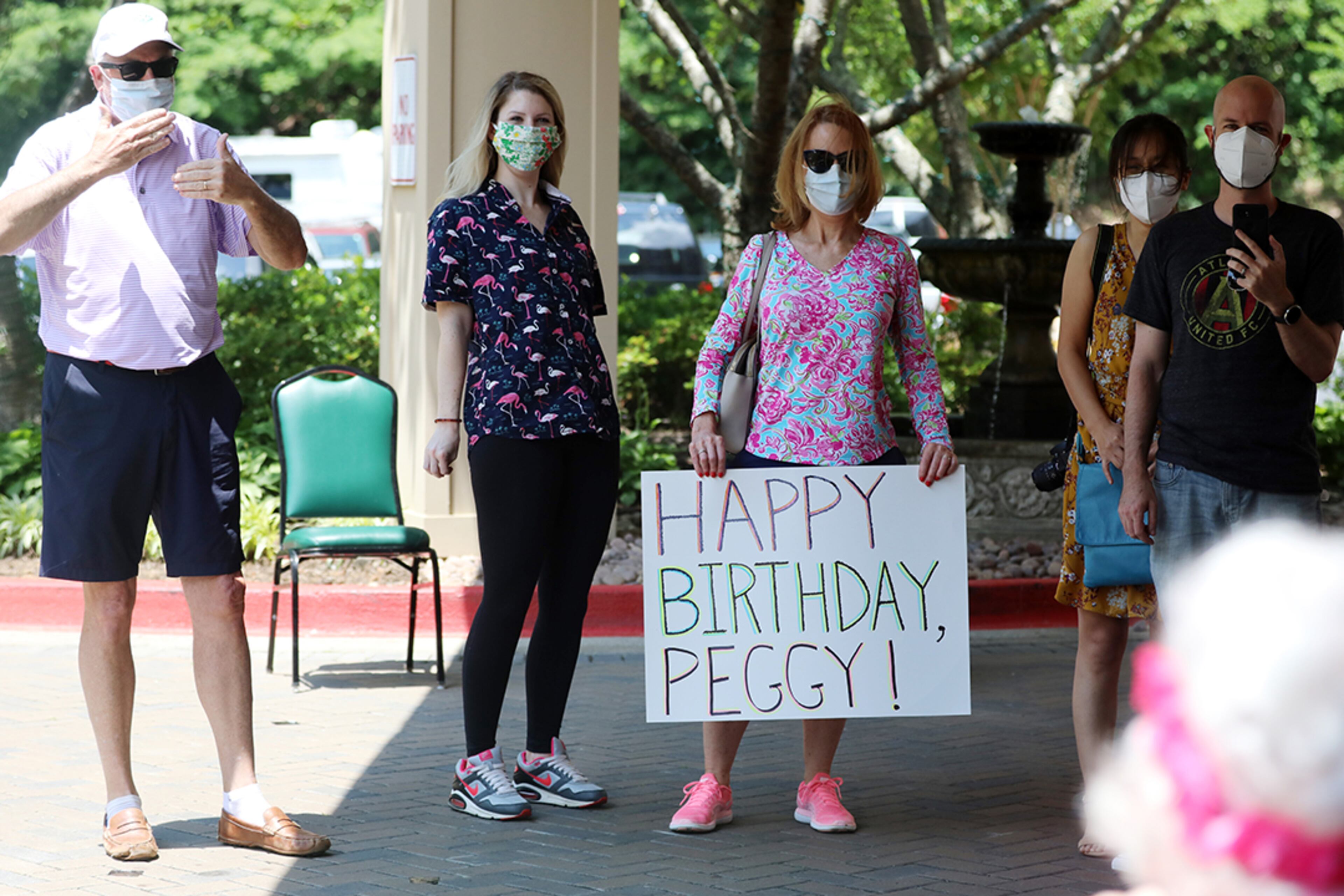 Friends and family members sing "Happy Birthday" to Peggy Cobb at the Hammond Glen Retirement Community on Friday, May 22, 2020. She turned 105 on Saturday. (Photo: Miguel Martinez for The Atlanta Journal-Constitution)
