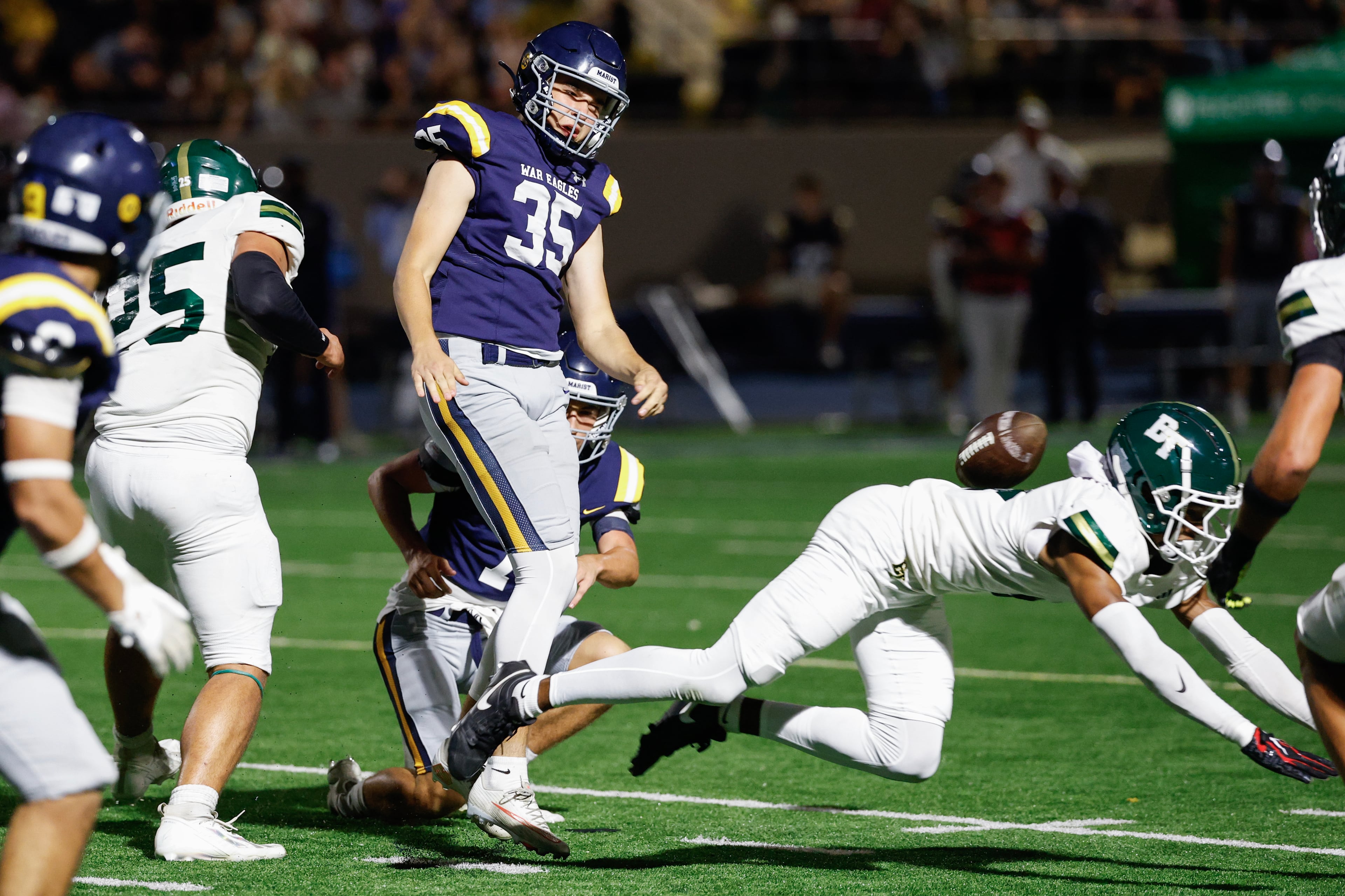 Marist’s Tyler Baradel (center) has a field goal attempt blocked by Blessed Trinity’s Noah Willis during their game on Friday, Sept. 25, 2026, in Atlanta. (Erik S. Lesser for the AJC)
