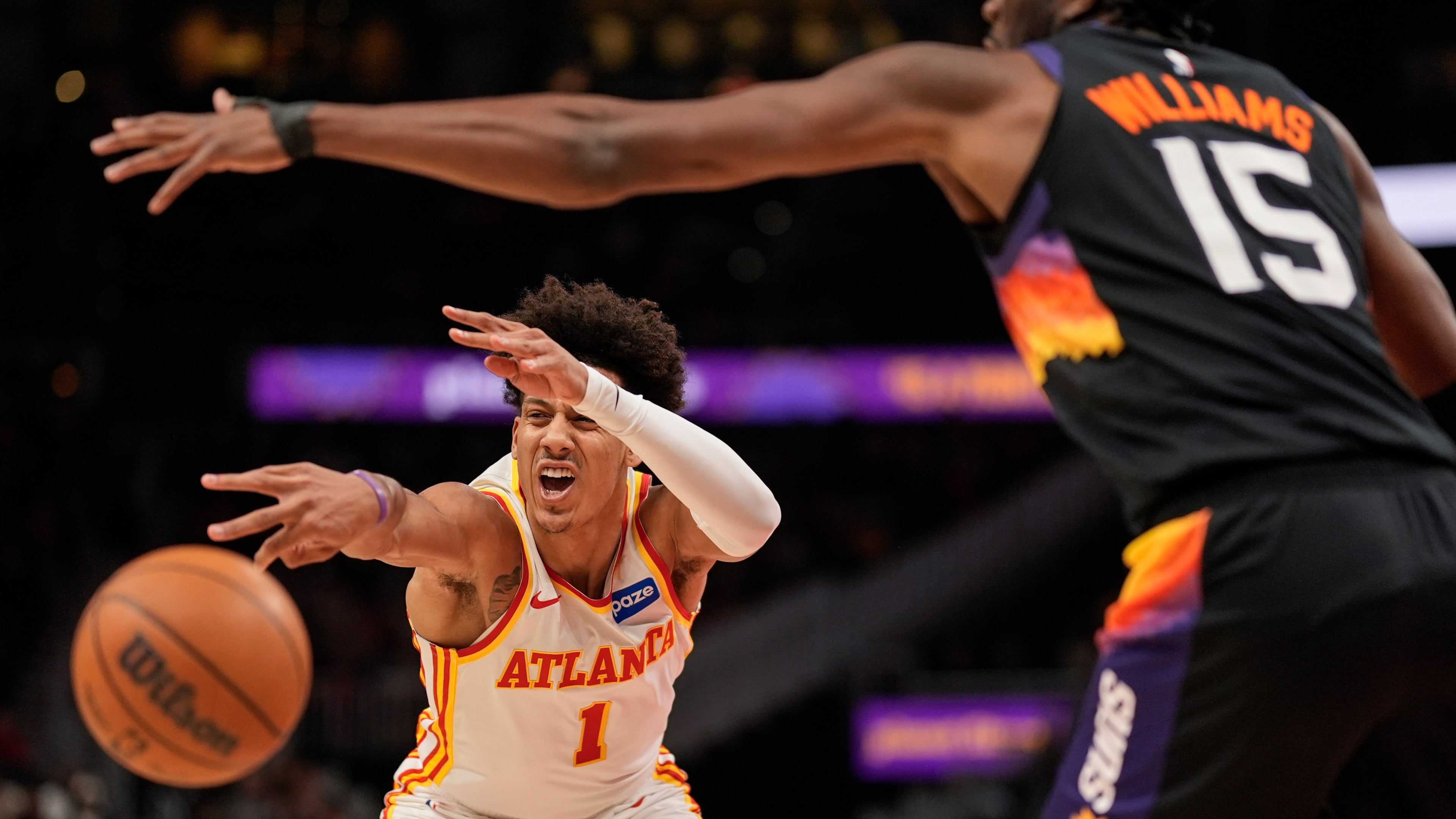 Atlanta Hawks forward Jalen Johnson (1) passes against Phoenix Suns center Mark Williams (15) during the first half of an NBA basketball game, Friday, Jan. 23, 2026, in Atlanta. (AP Photo/Mike Stewart)