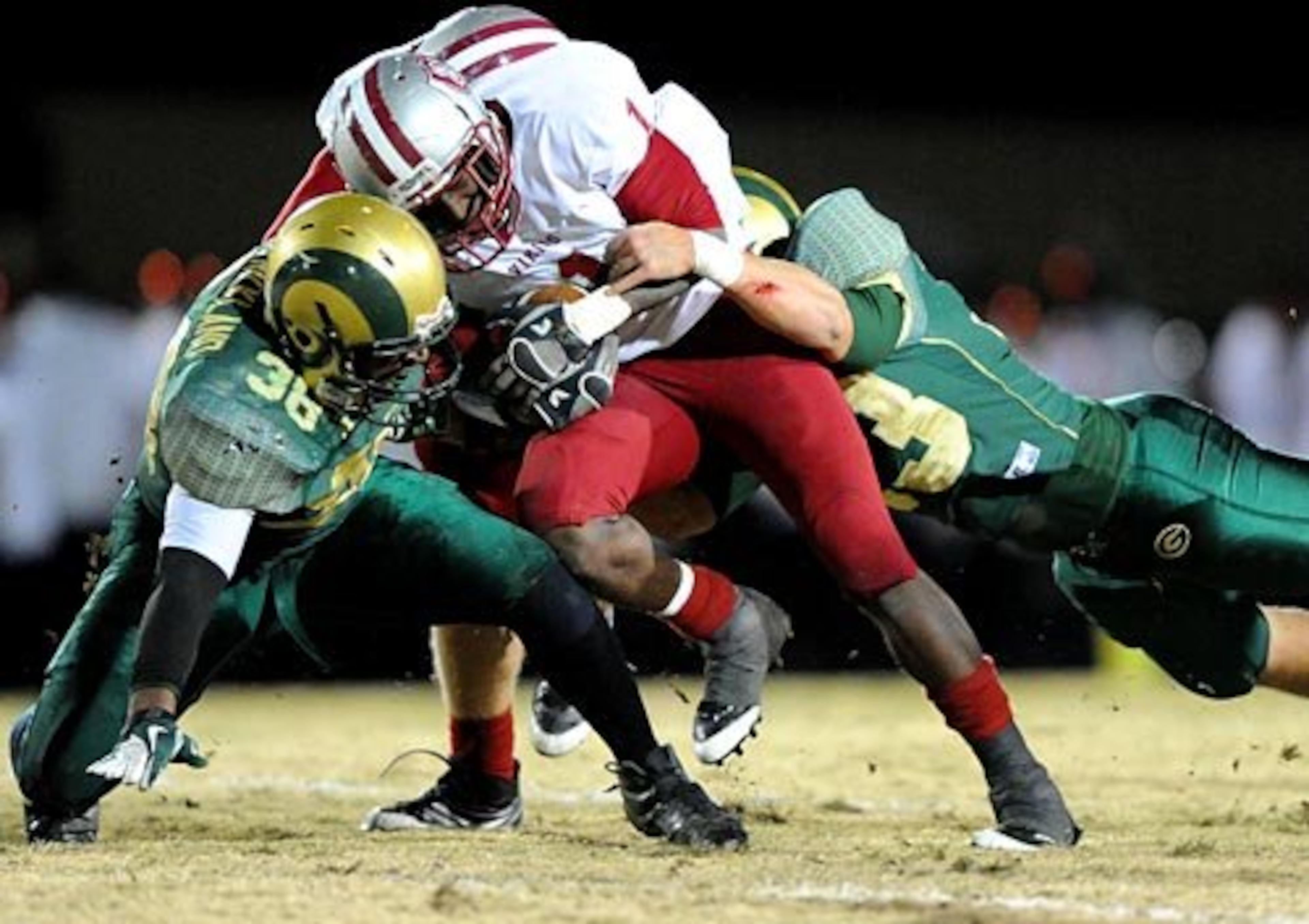 Lowndes' Mike Moore is tackled by Grayson's Jay Strickland (left) and Jake Mueller.
