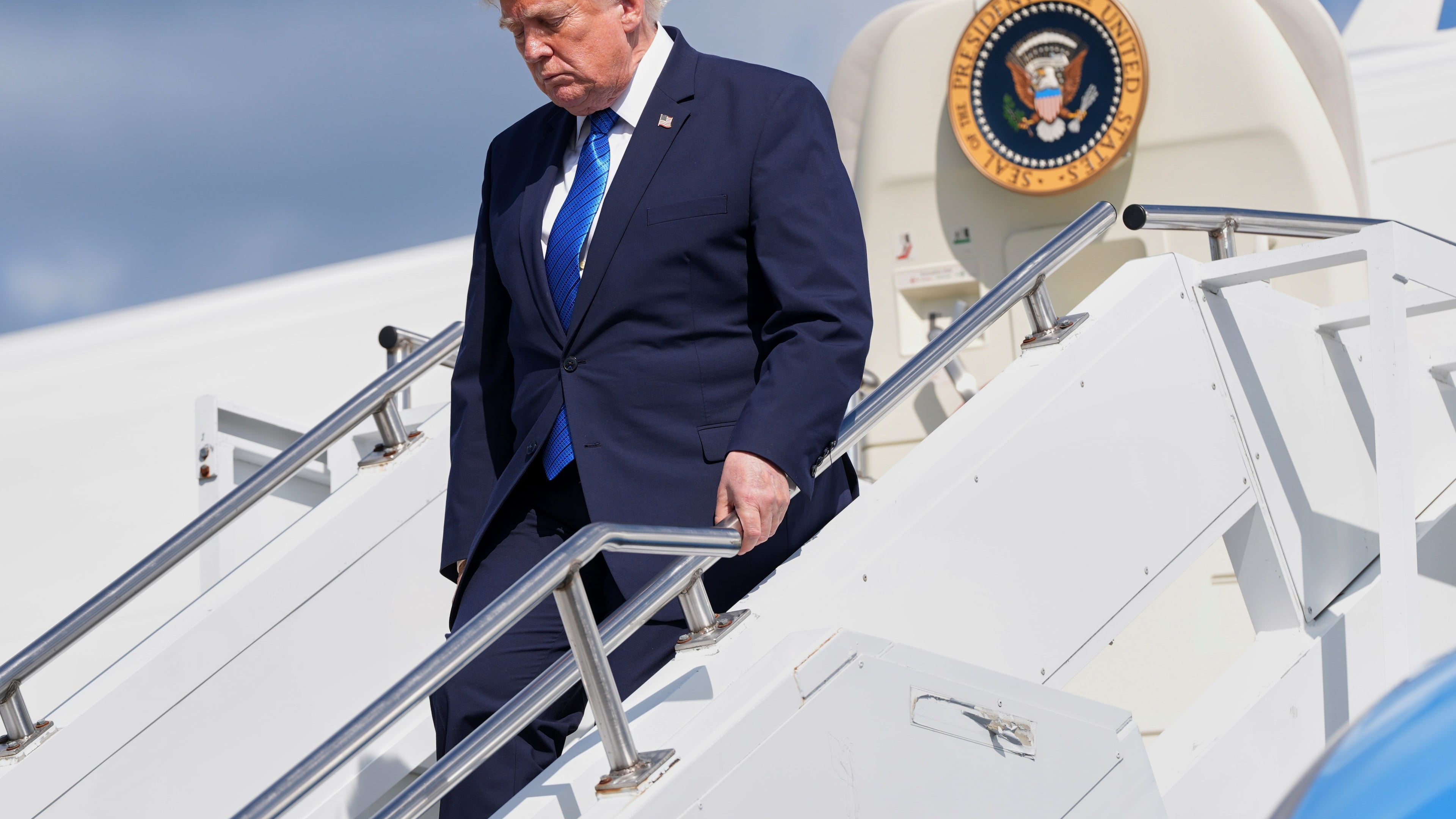 President Donald Trump exits Air Force One at Morristown Municipal Airport in Morristown, N.J., Friday, July 31, 2026, after a trip to Camp David, the presidential retreat. (AP Photo/Jacquelyn Martin)