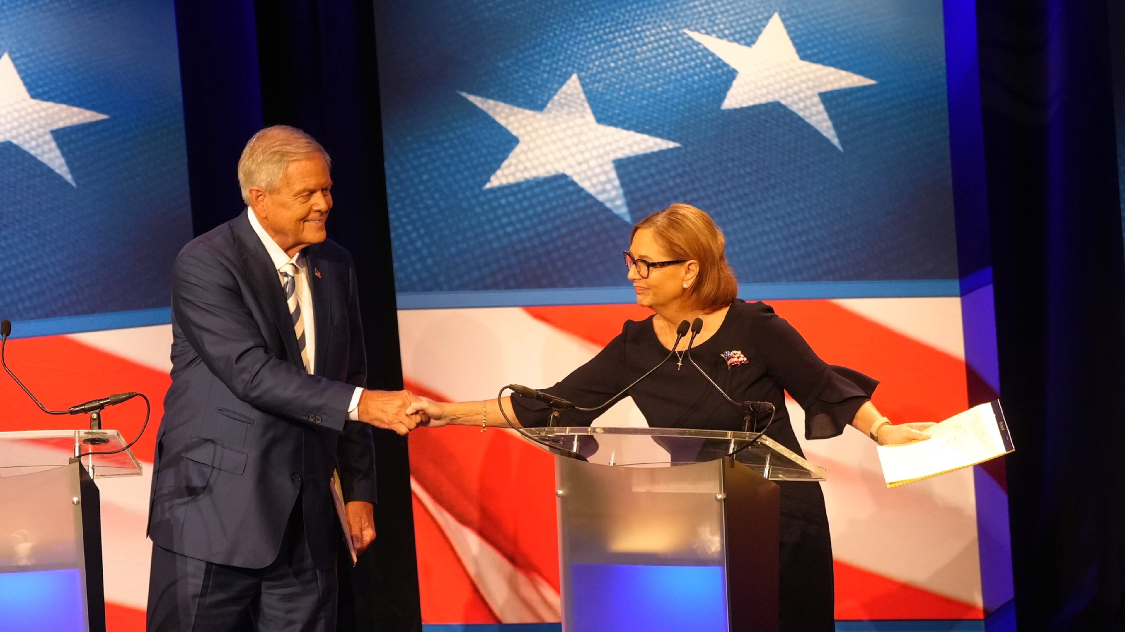 U.S. Rep. Ralph Norman, R-S.C., left, reaches over to shake hands with Sen. Darline Graham, R-S.C., during a debate ahead of the special GOP Senate runoff election to replace the late Sen. Lindsey Graham, R-S.C., in Newberry, S.C., Tuesday, Aug. 18, 2026. (AP Photo/Meg Kinnard)