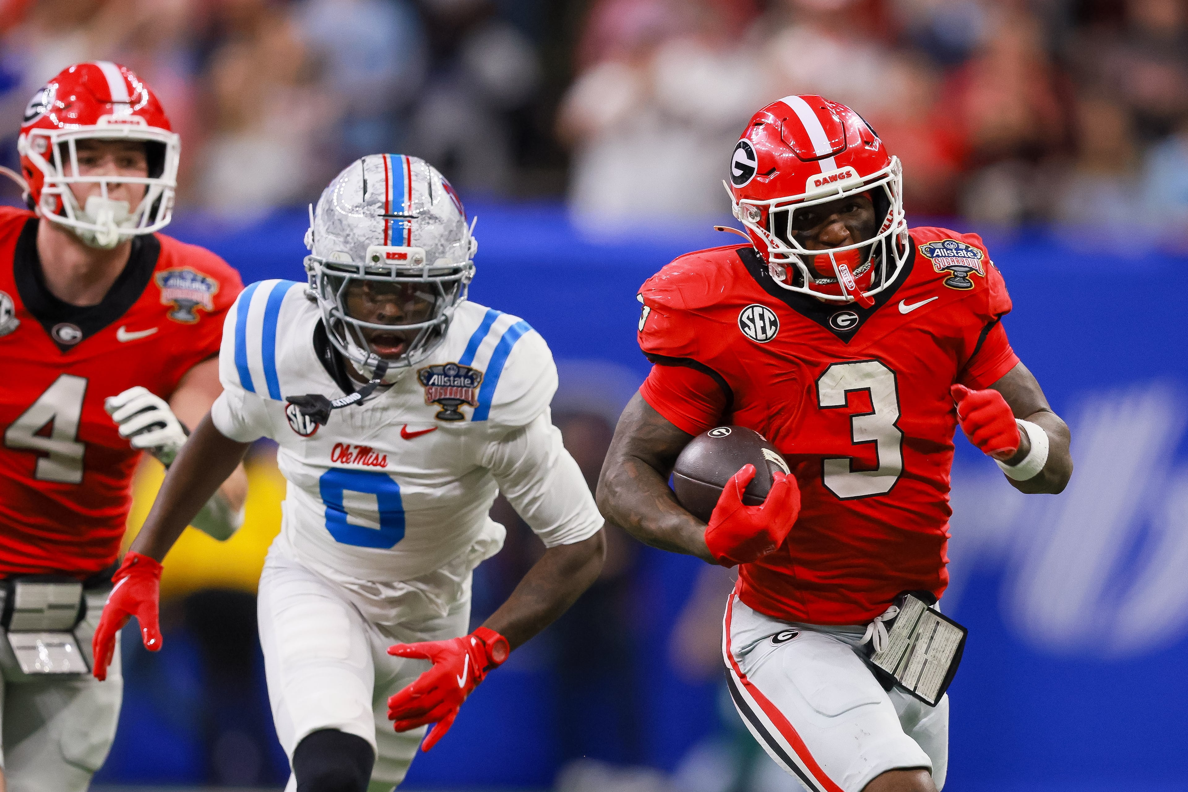 Georgia Bulldogs running back Nate Frazier (3) runs past Ole Miss Rebels cornerback Antonio Kite (8) during the second quarter of the College Football Playoff quarterfinal game at the Sugar Bowl in the Caesars Superdome, Thursday, Jan. 1, 2026, in New Orleans. (Jason Getz/AJC)