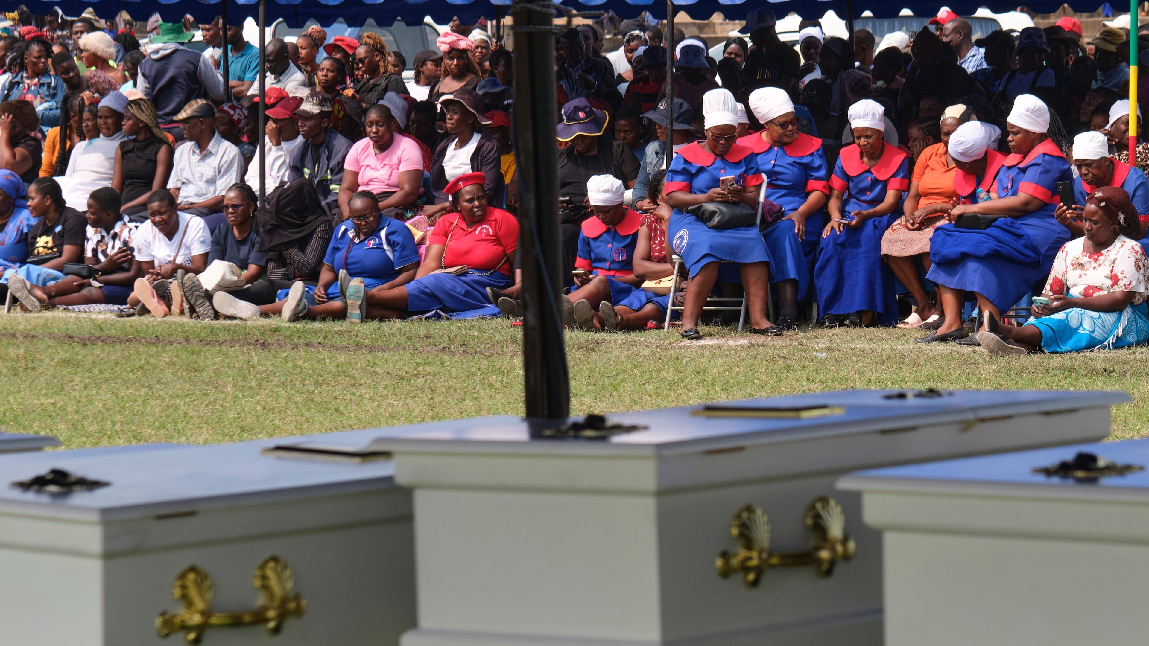 Mourners gather for a memorial service for the victims of a ferry capsized on lake Kariba in Kariba, Zimbabwe, Thursday, Aug. 13, 2026. (AP Photo/Mkhululi Thobela)