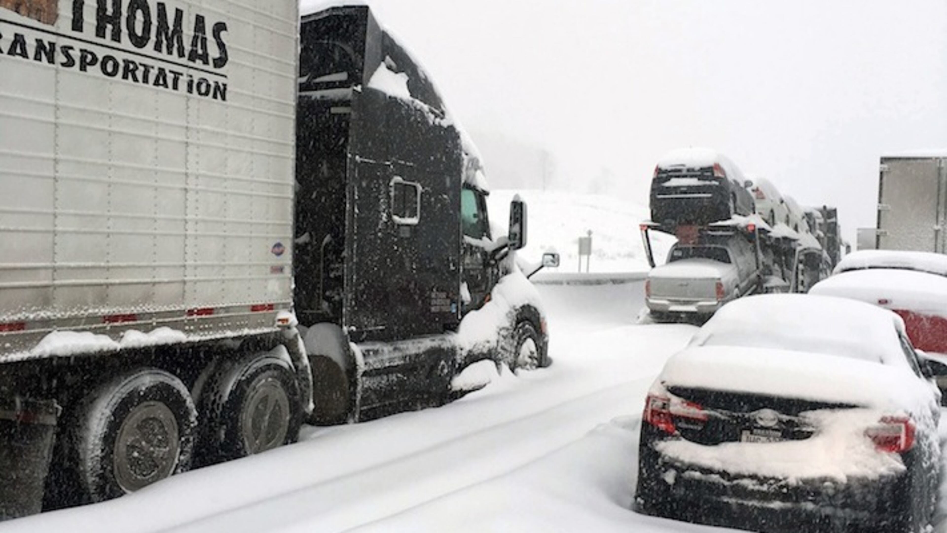In this photo provided by Michael Watkins, traffic is at a standstill on the Pennsylvania Turnpike near Bedford, Pa., Saturday, Jan. 23, 2016. The Duquesne men's basketball team and Temple University's women's gymnastics team are stuck on the Turnpike due to treacherous weather conditions. A mammoth winter storm crawled up the U.S. East Coast on Saturday, making roads impassable, shutting down mass transit, and bringing Washington and New York City to a standstill. (AP Photo/Michael Watkins via AP)