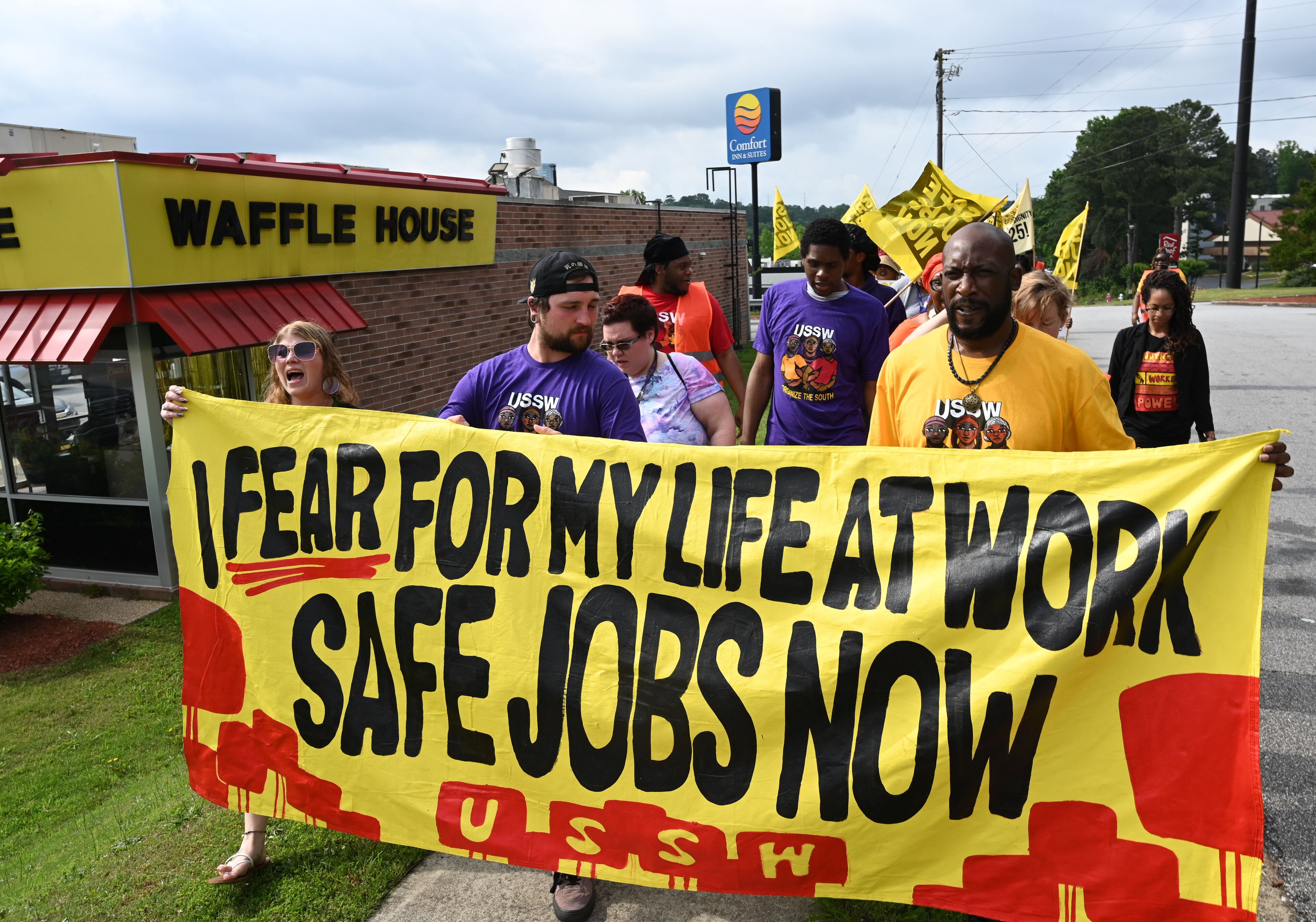 Waffle House employees and Union of Southern Service Workers organizers rally outside the Waffle House on Windy Hill Road in Marietta on Friday. The USSW, which represents low-wage workers in the service industry, has posted a petition with demands for Waffle House to raise employees’ base pay, end a mandatory deductions policy for worker meals and provide 24-hour security at restaurants. (Hyosub Shin/AJC)
