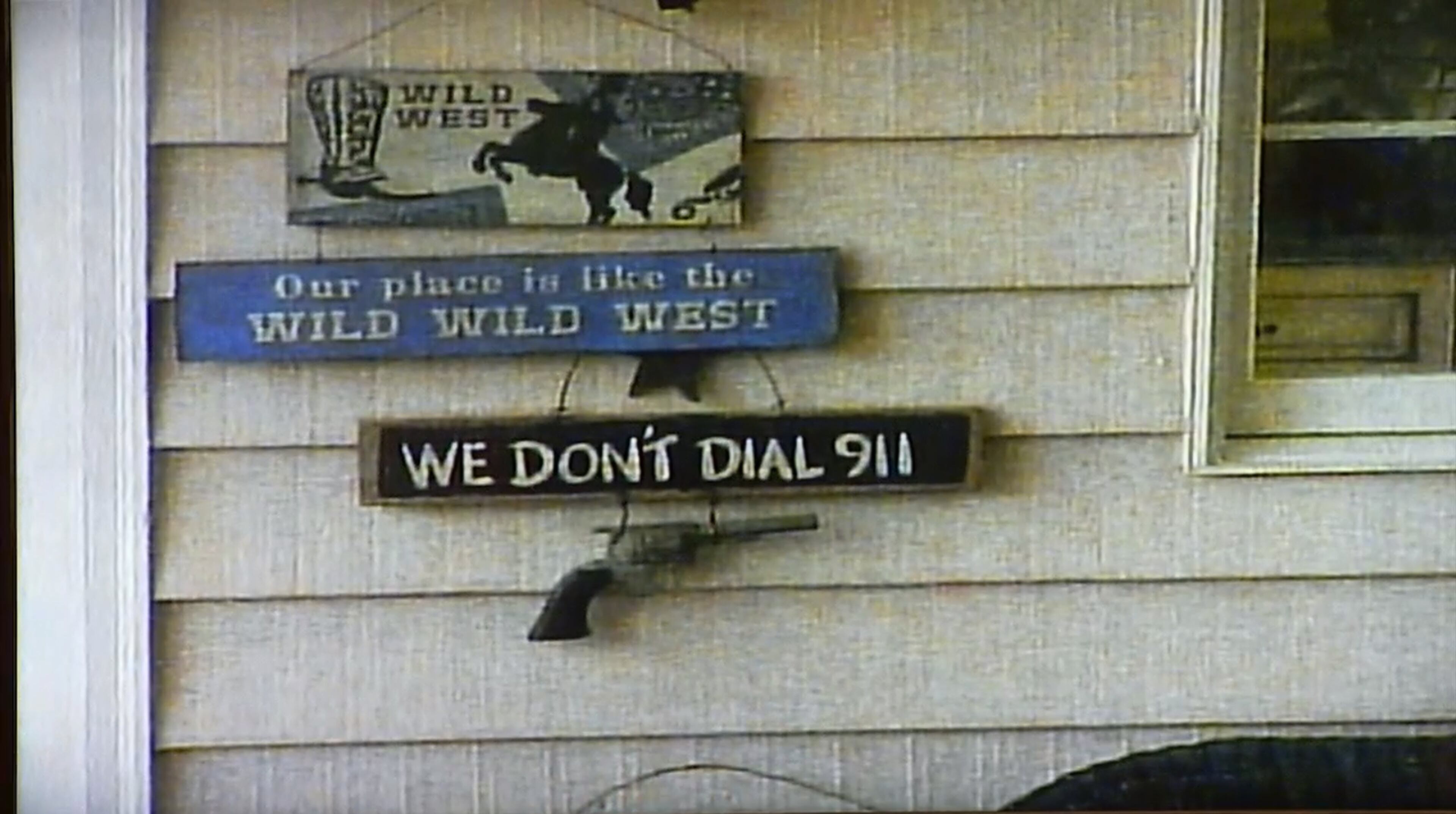 An image of the McIvers' home in Eatonton, Ga, is shown to the court during the testimony of Terri Jackson, an investigator with the DeKalb County District Attorneyâs office. Jackson said that the "We don't dial 911" sign by the door caught her eye during a visit to the property. She testified in the murder trial of Tex McIver on March 14, 2018 in the Fulton County Courthouse. (Channel 2 Action News)