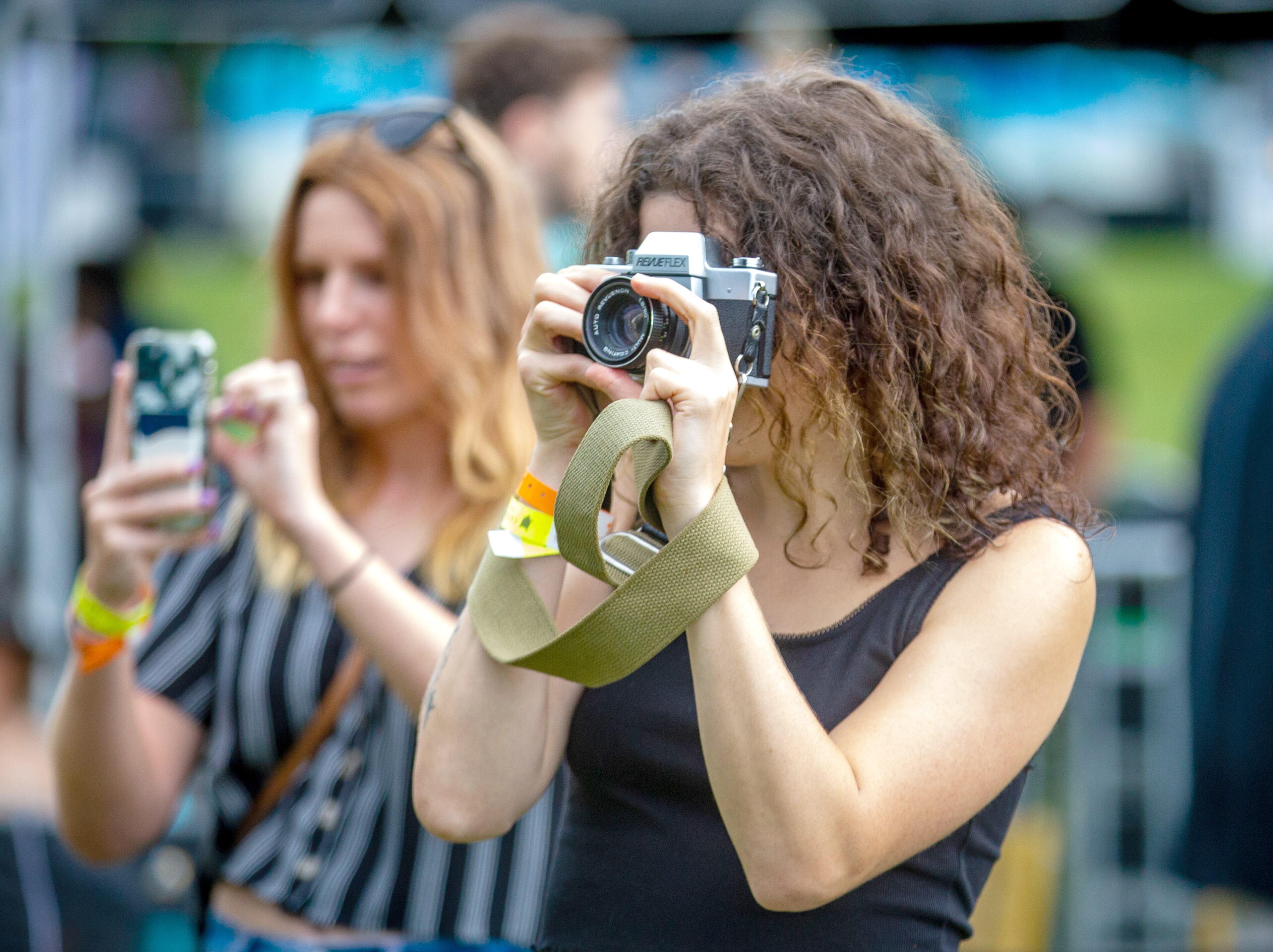 Paige Wayton (right) takes a photograph of the band Pink Stones during the Lost Art Music Festival in Douglasville on Saturday, June 12, 2021. STEVE SCHAEFER FOR THE ATLANTA JOURNAL-CONSTITUTION