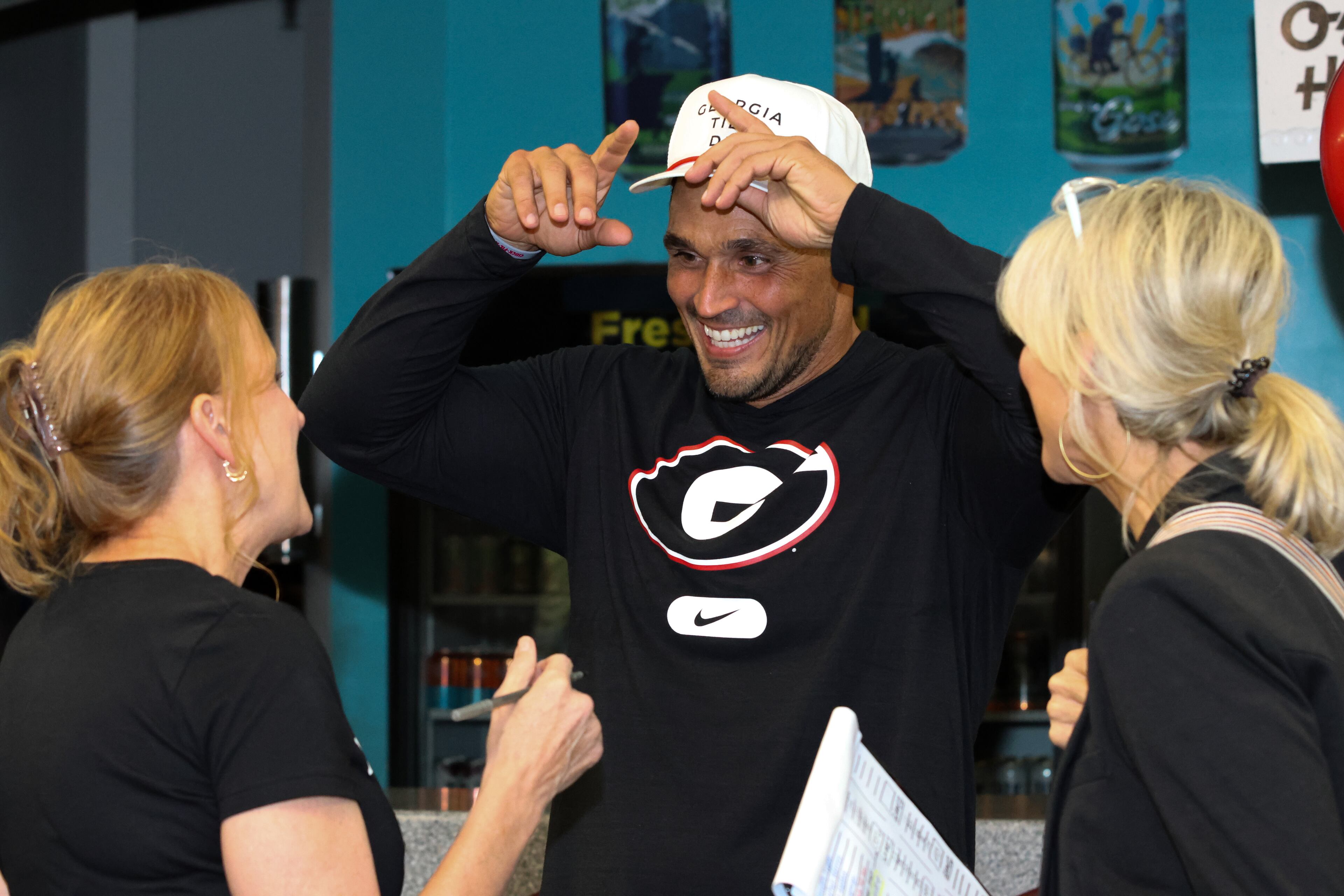 Football analyst and former UGA defensive end David Pollack (center) was among many current and former players attending the third annual Chick-fil-A Dawg Bowl fundraiser for Parkinson’s and Crohn’s disease research at Showtime Bowl in Athens on Wednesday, Oct. 22, 2025. (C.J. Bartunek for the AJC)