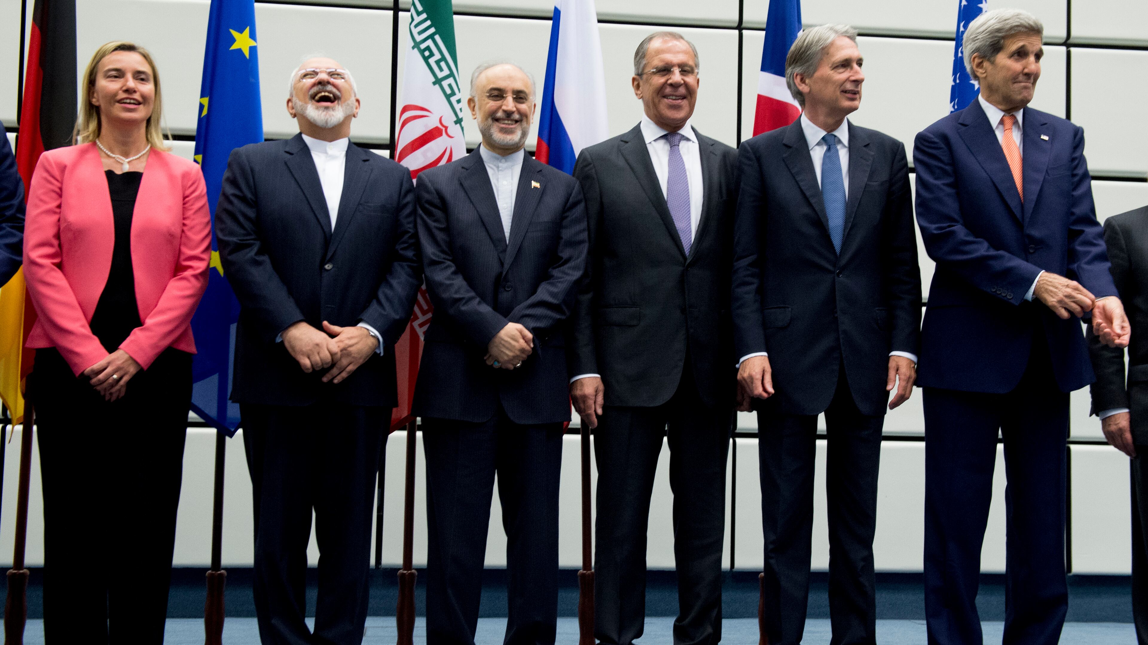 From left to right: European Union High Representative Federica Mogherini, Iranian Foreign Minister Mohammad Javad Zarif, Head of the Iranian Atomic Energy Organization Ali Akbar Salehi, Russian Foreign Minister Sergey Lavrov, British Foreign Secretary Philip Hammond and US Secretary of State John Kerry pose for a group picture at the United Nations building in Vienna, Austria, Tuesday, July 14, 2015. After 18 days of intense and often fractious negotiation, diplomats Tuesday declared that world powers and Iran had struck a landmark deal to curb Iran's nuclear program in exchange for billions of dollars in relief from international sanctions, an agreement designed to avert the threat of a nuclear-armed Iran and another U.S. military intervention in the Muslim world. (Joe Klamar/Pool Photo via AP)
