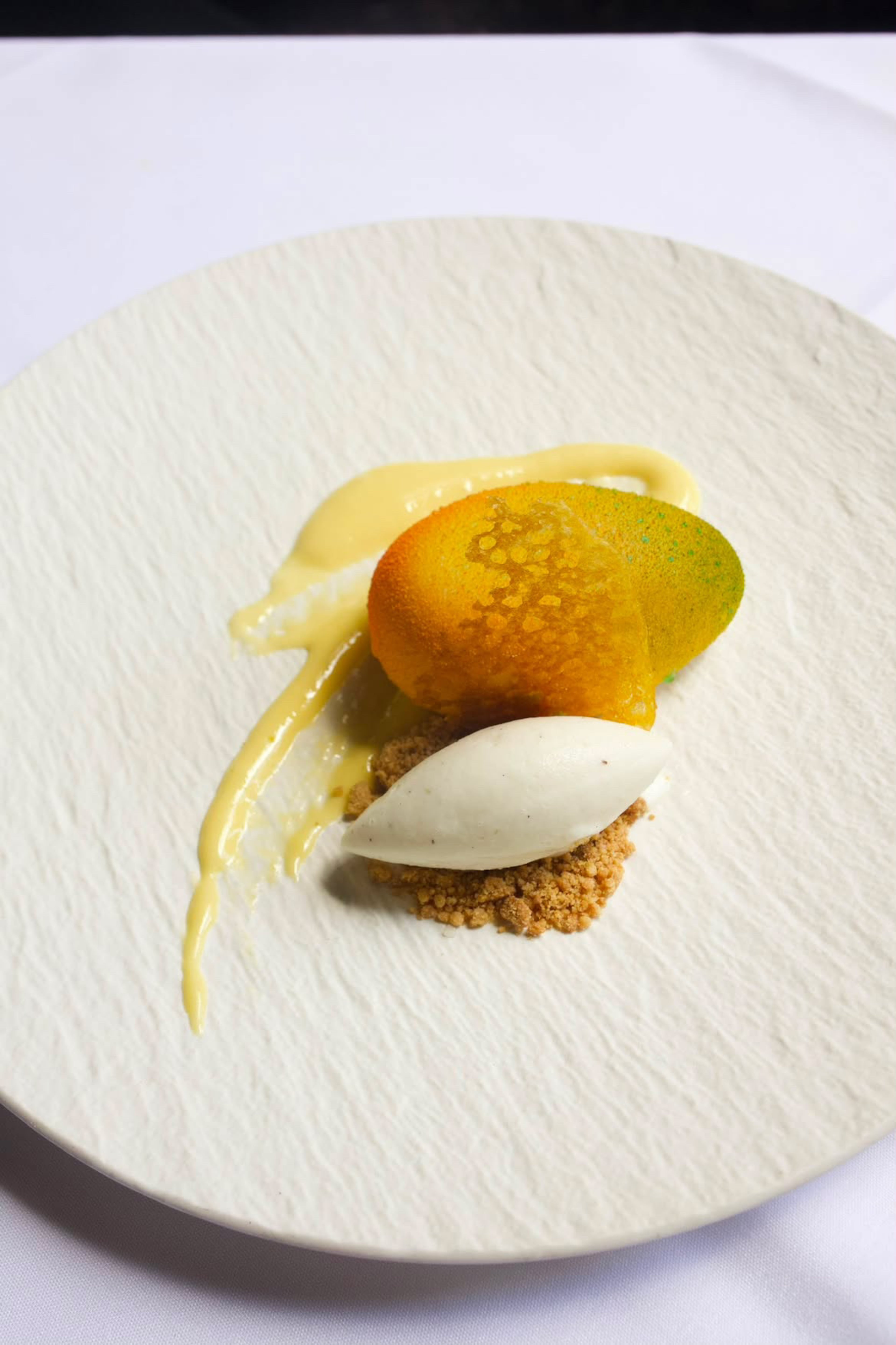 Witchsugar’s mango mousse with fresh mangoes, sabayon, kinako cookie crumb and Champagne sorbet. (Courtesy of Prime)