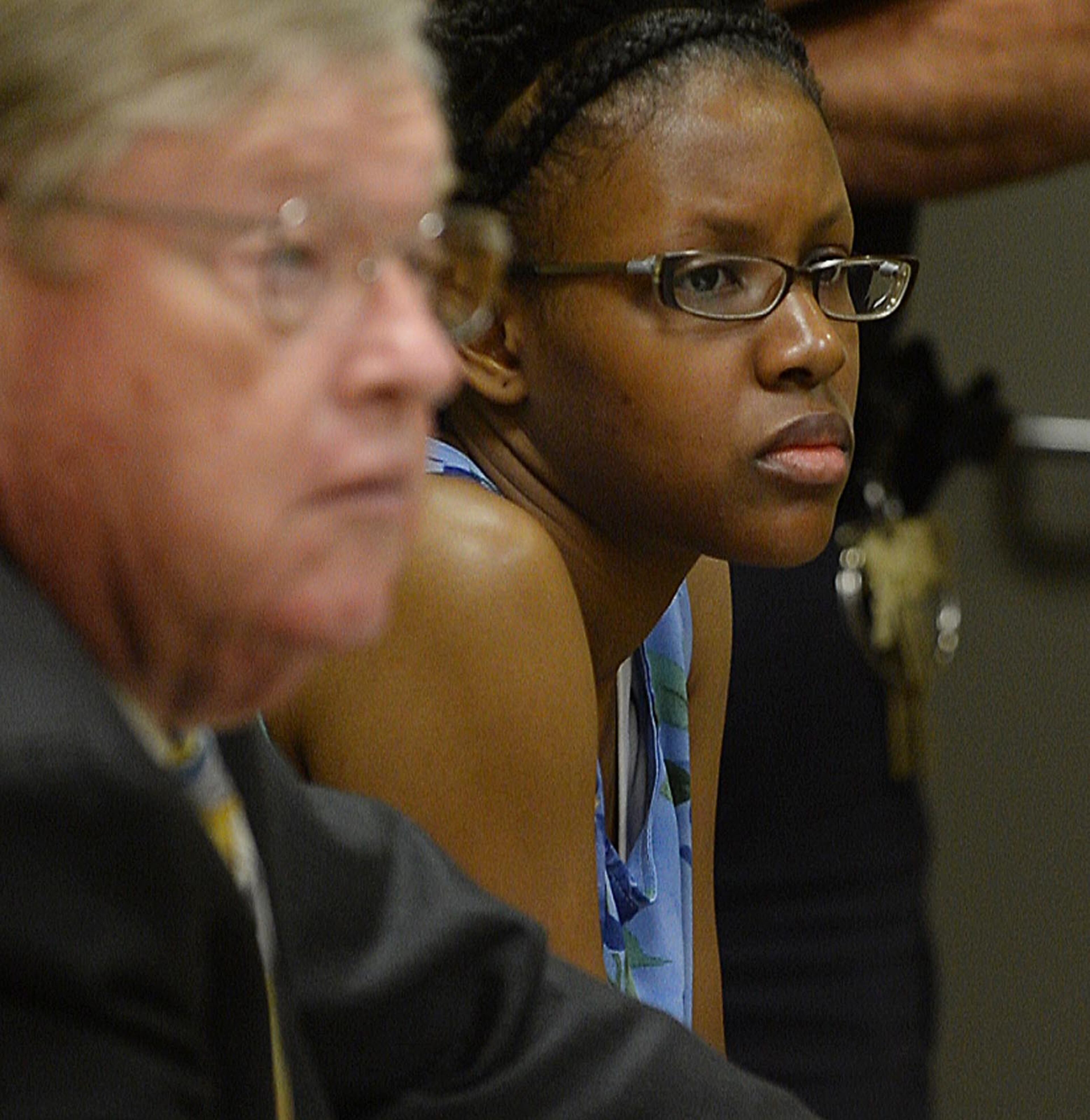 Najlaa McIntosh listens as GCPD Detective James Sweeney testifies. Chief Magistrate Kristina Hammer Blum presides over hearing for a Gwinnett man and his daughter who are charged with starving the man's child to death and withholding food from the child's 21-year-old mother, who weighed 59 pounds when she was found. Calvin McIntosh and his daughter, Najlaa, appear in the probable cause hearing Friday, December 5, 2014. Judge Blum found there was probably cause for cruelty to children and murder charges and bound their case over to Superior Court. She said that due to the charges, the court did not have jurisdiction to set a bond. KENT D. JOHNSON/KDJOHNSON@AJC.COM