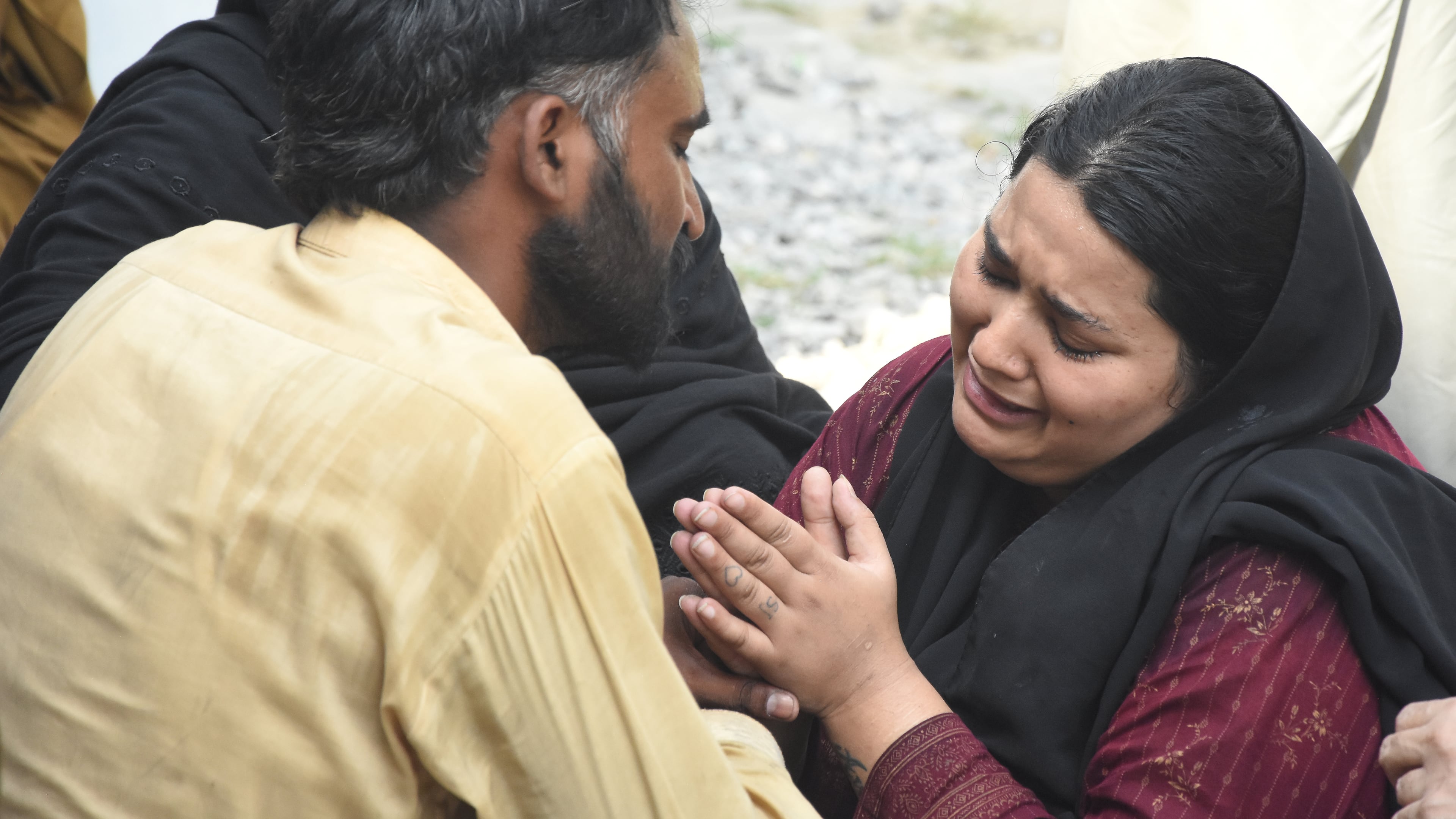 Parents react after their child died in a hospital fire in Islamabad, Pakistan, Wednesday, Aug. 26, 2026. (AP Photo/