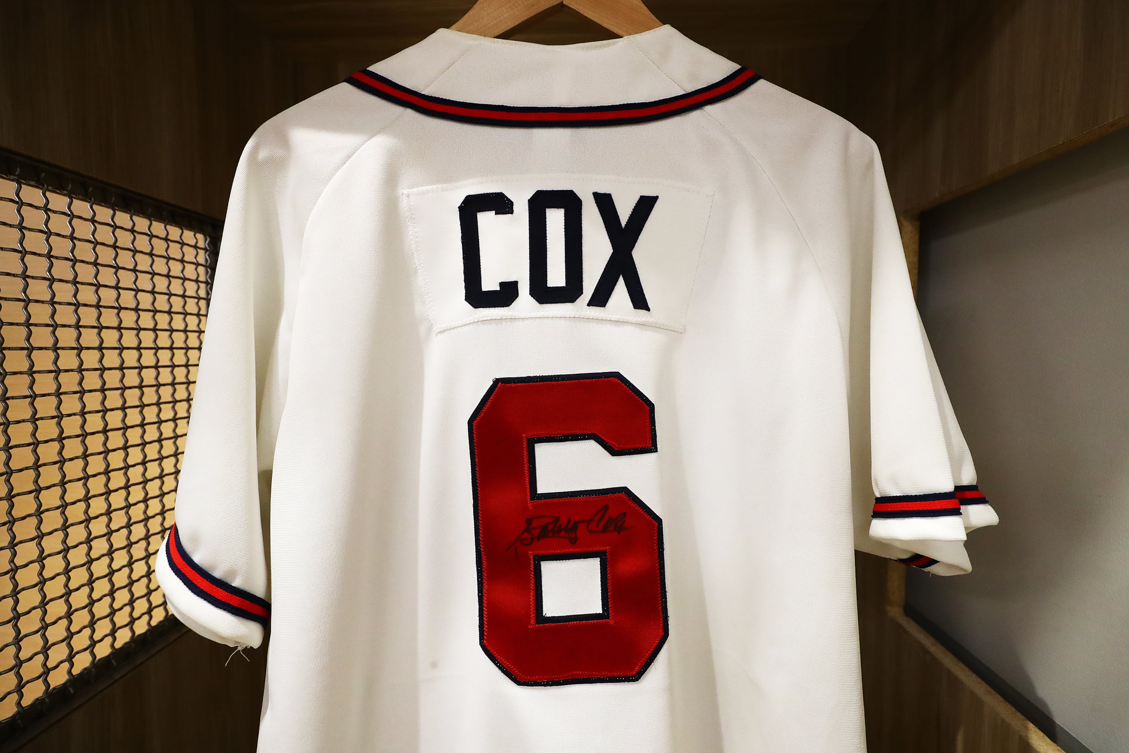 An autographed Bobby Cox jersey honoring the former manager of the Atlanta Braves hangs inside a locker at the Legends Club at CoolToday Park in North Port, Fla. (Curtis Compton/AJC 2022)