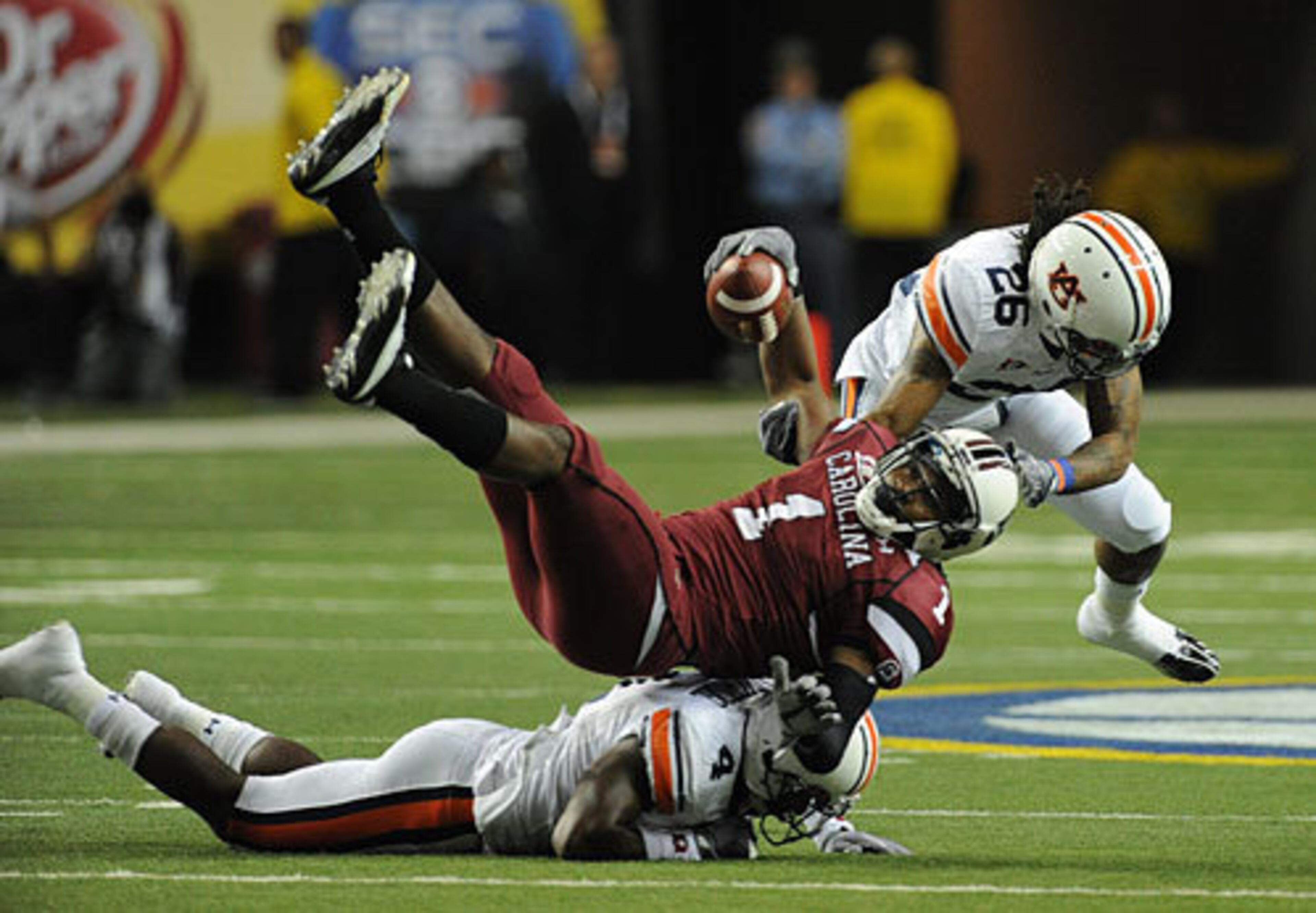 South Carolina's Alshon Jeffery (1) hangs in the air as Auburn's Zac Etheridge (4) hits him low and Auburn's Mike McNeil (26) hits him high during the first quarter
