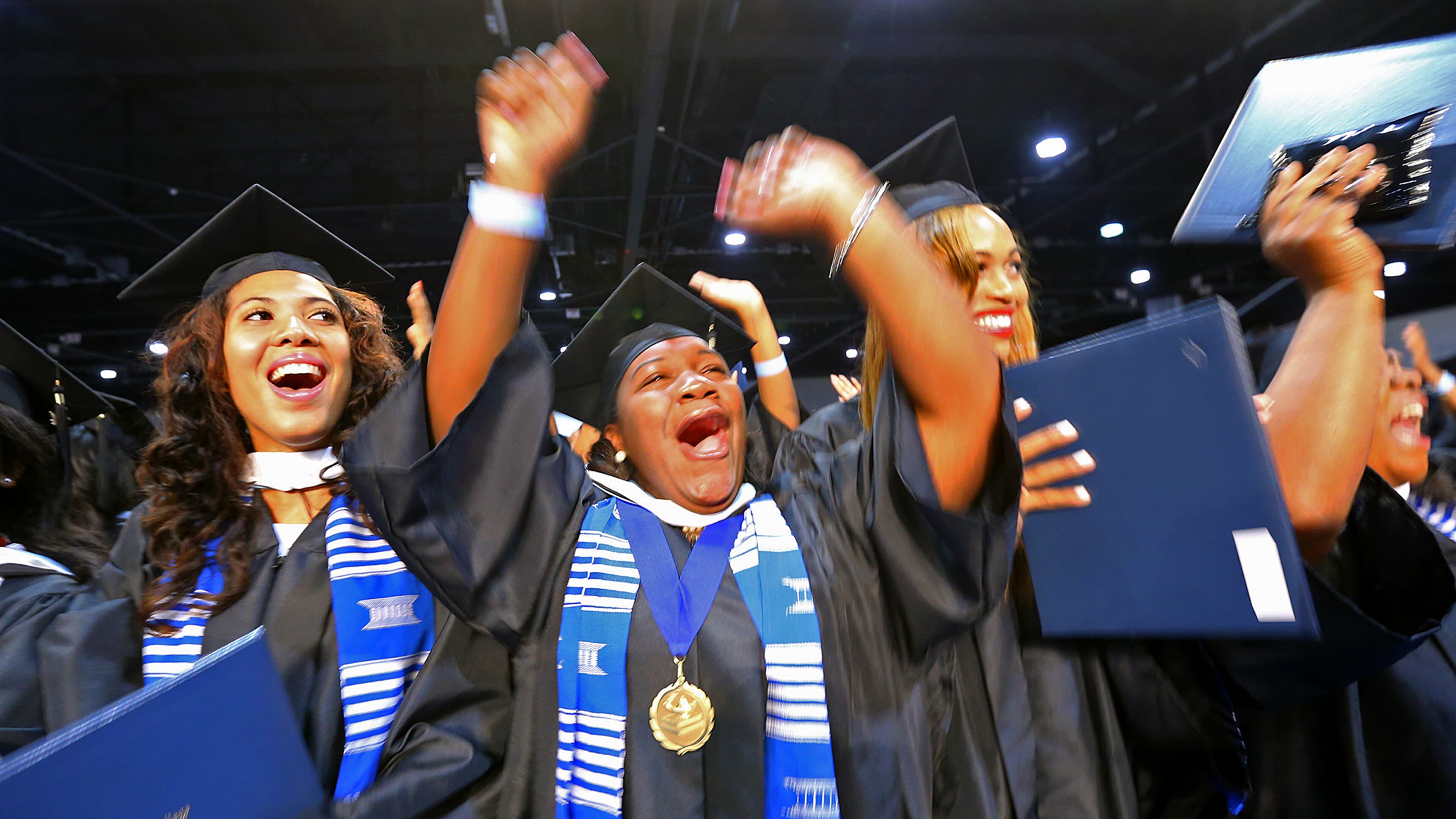Graduates Kierstin Stradford, Dana Stigler, Shelley Stewart, and Jameela Stanton react at the end of the Spelman College 127th Commencement at the Georgia World Congress Center on Sunday, May 18, 2014, in Atlanta. CURTIS COMPTON / CCOMPTON@AJC.COM