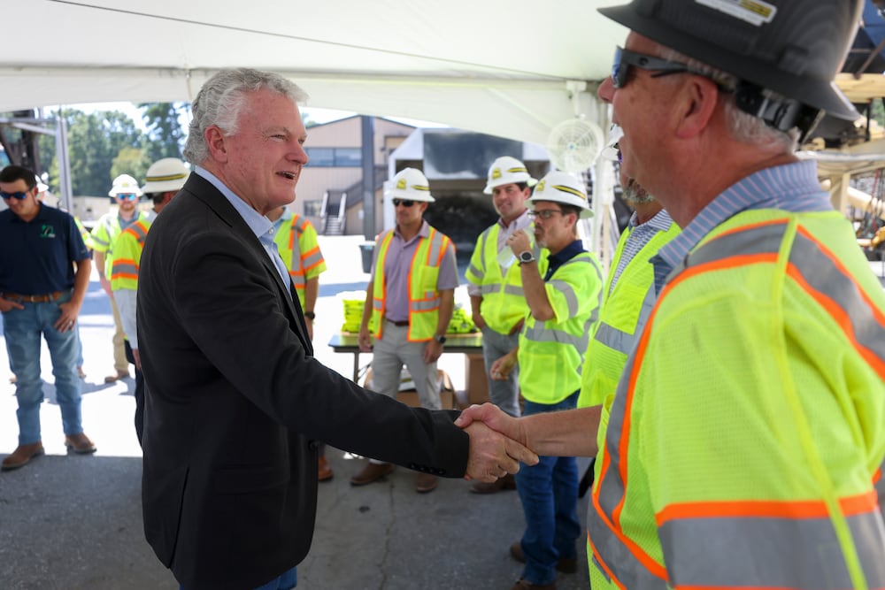 U.S. Rep. Mike Collins meets industry leaders as he tours an asphalt plant in Norcross in August. (Jason Getz/AJC)