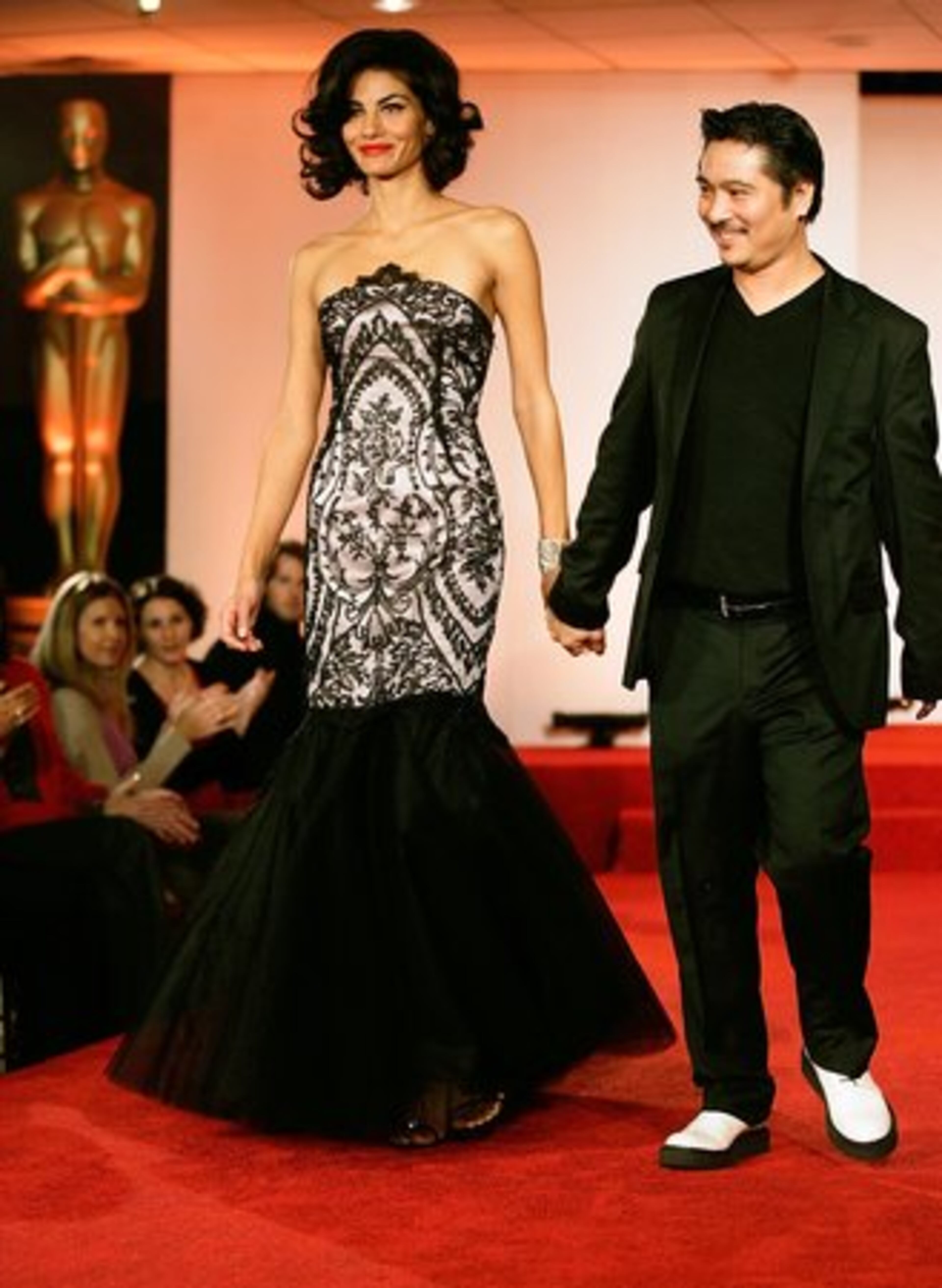 Model Morgan Hewitt, left, wears a strapless French lace and pink silk mermaid gown by designer Alan del Rosario, right.