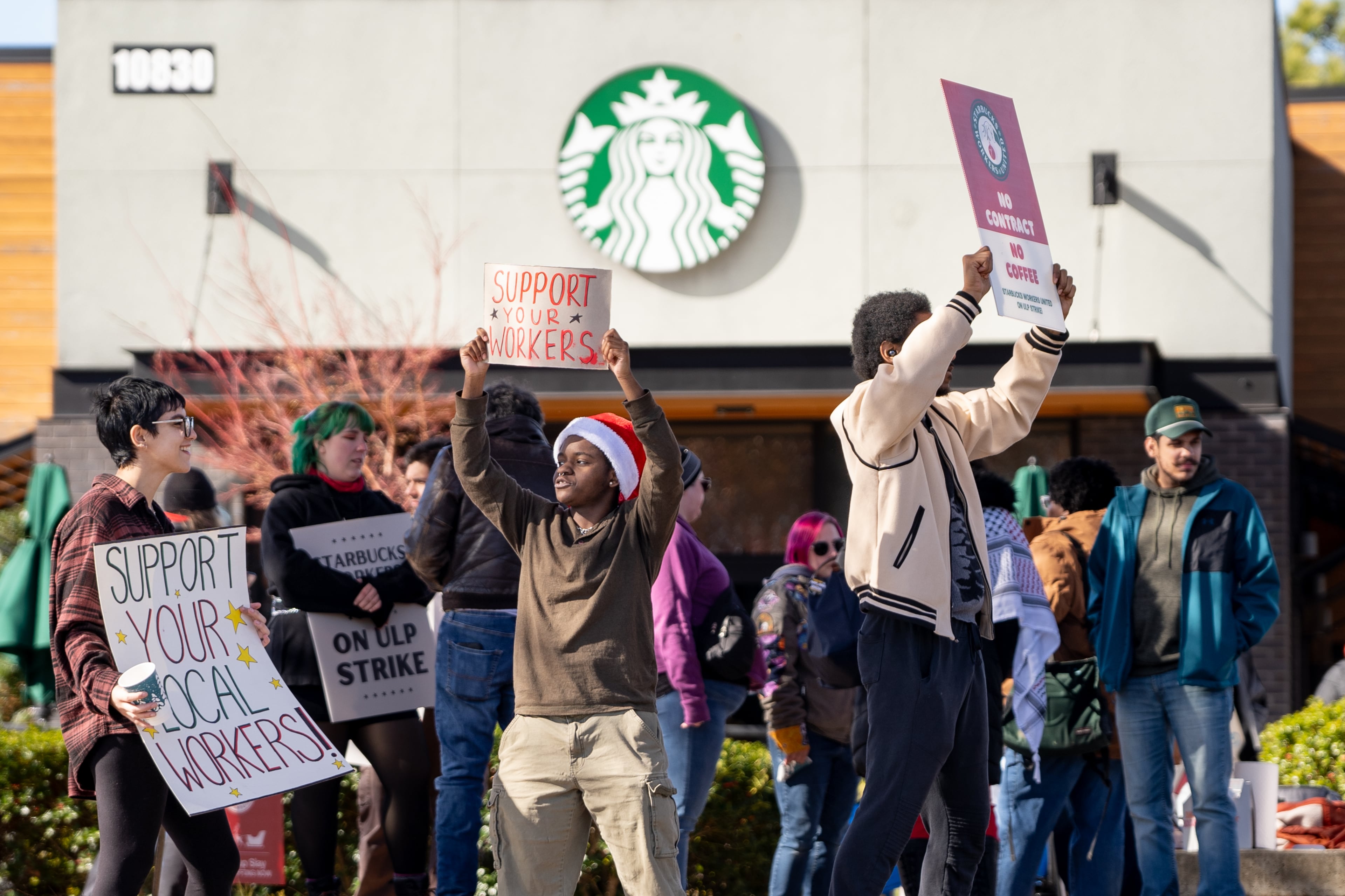Starbucks Baristas protest outside of the Haynes Bridge location in Alpharetta, Georgia to demand better pay. Tuesday, Dec. 24, 2024 (Ben Hendren for the AJC)