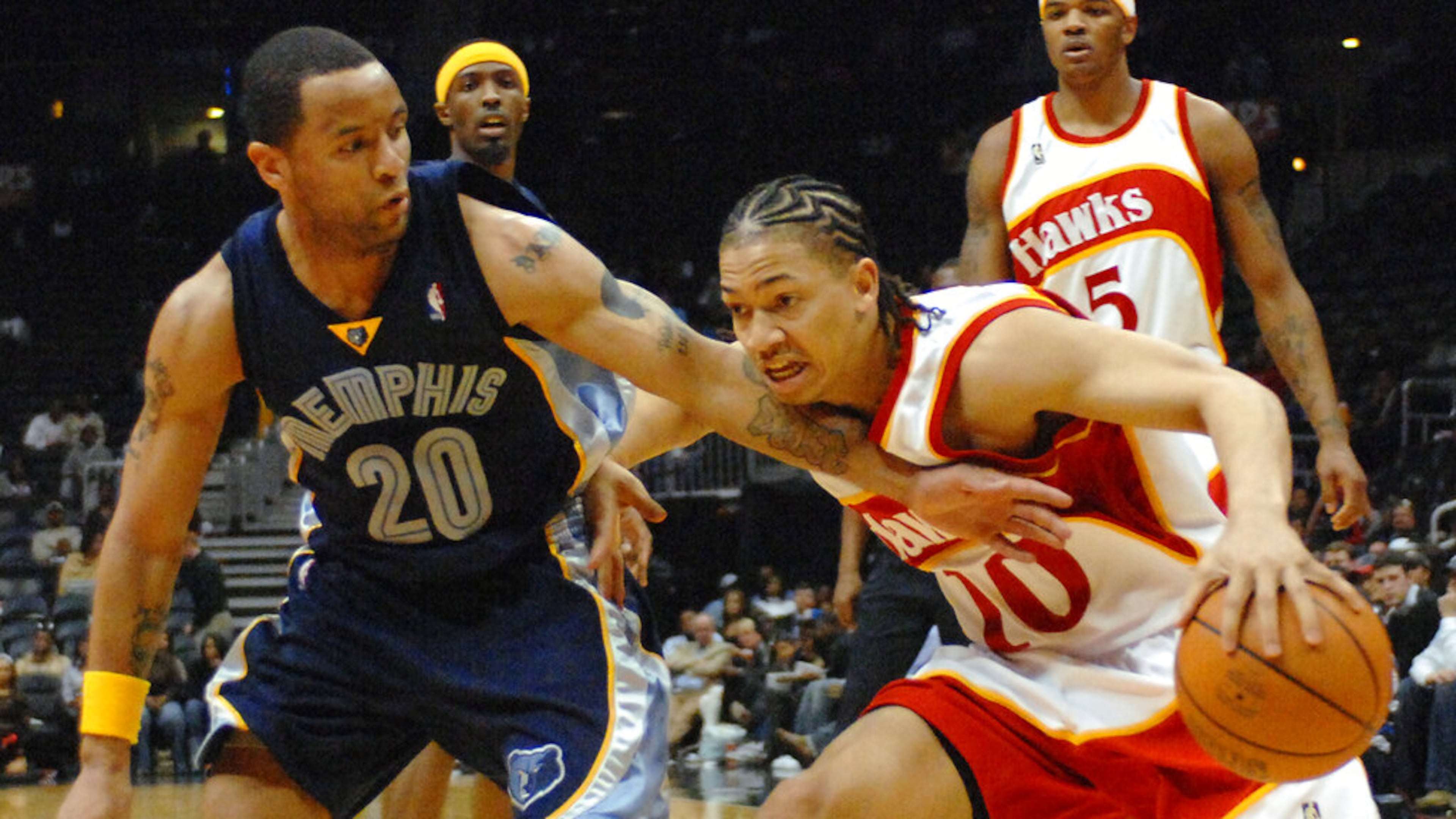 Hawks guard Tyronn Lue (right) drives against Grizzlies guard Damon Stoudamire during the third quarter Friday, March 9, 2007, in Atlanta. (Gregory Smith/AP)