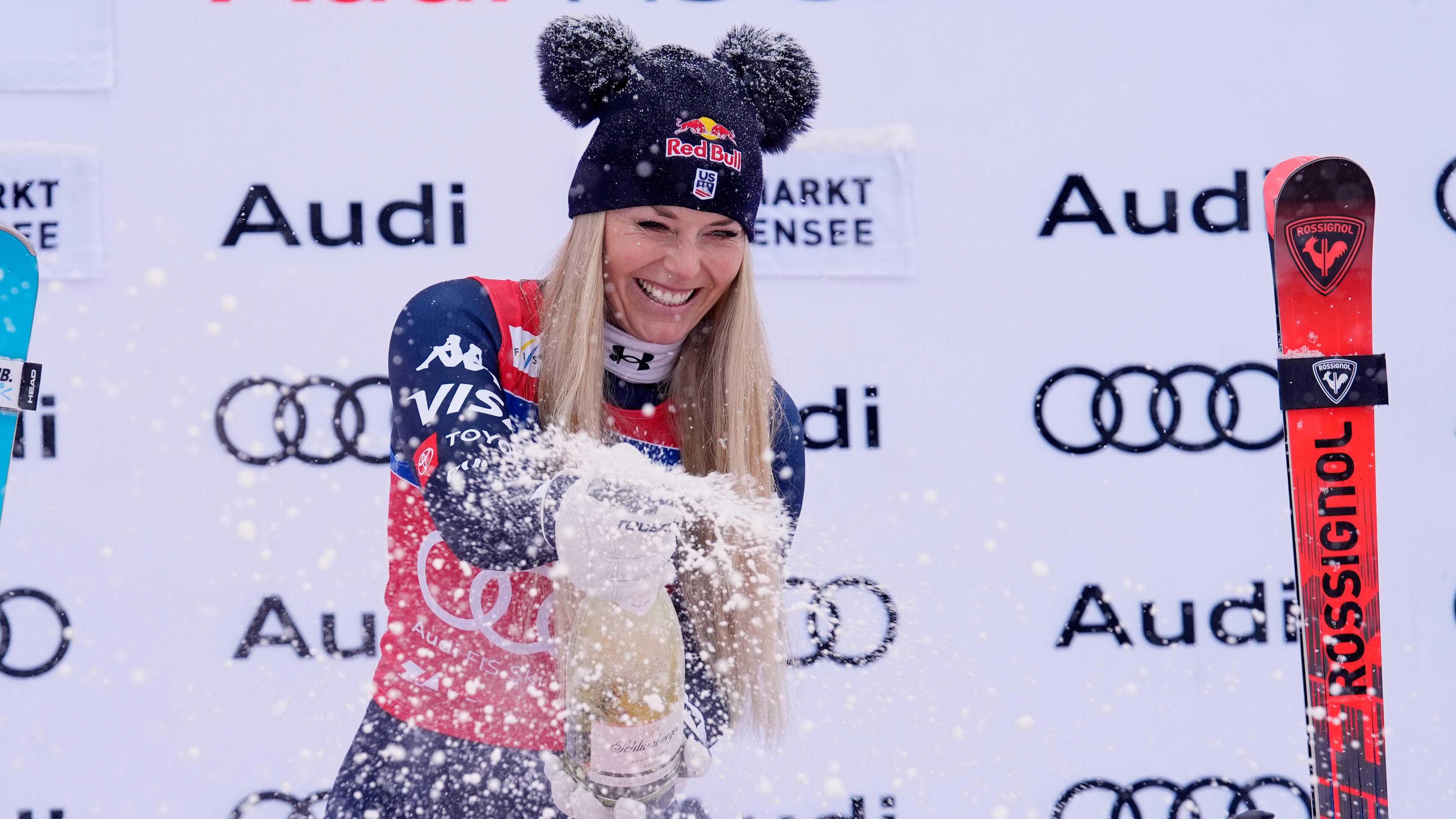 United States' Lindsey Vonn sprays sparkling wine as she celebrates on podium after winning an alpine ski, women's World Cup downhill, in Zauchensee, Austria, Saturday, Jan. 10, 2026. (AP Photo/Giovanni Auletta)