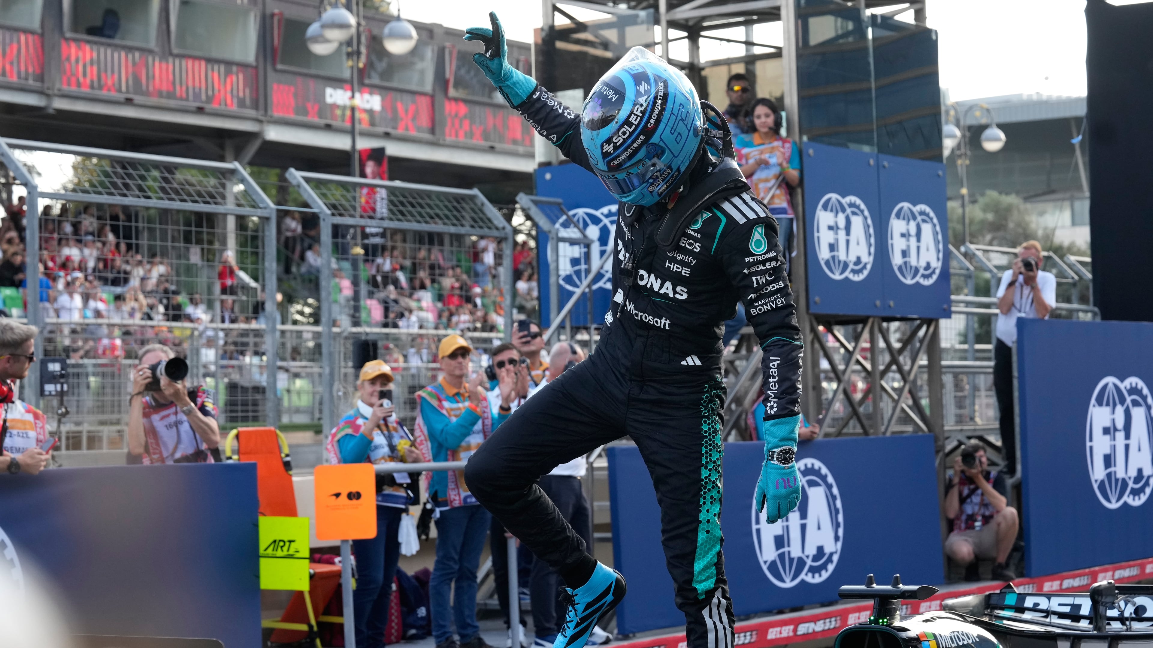 Mercedes driver George Russell of Britain celebrates after he clocked the fastest time during the qualifying session for the Azerbaijan F1 Grand Prix, in Baku, Azerbaijan, Friday, Sept. 25, 2026. (AP Photo/Darko Bandic)