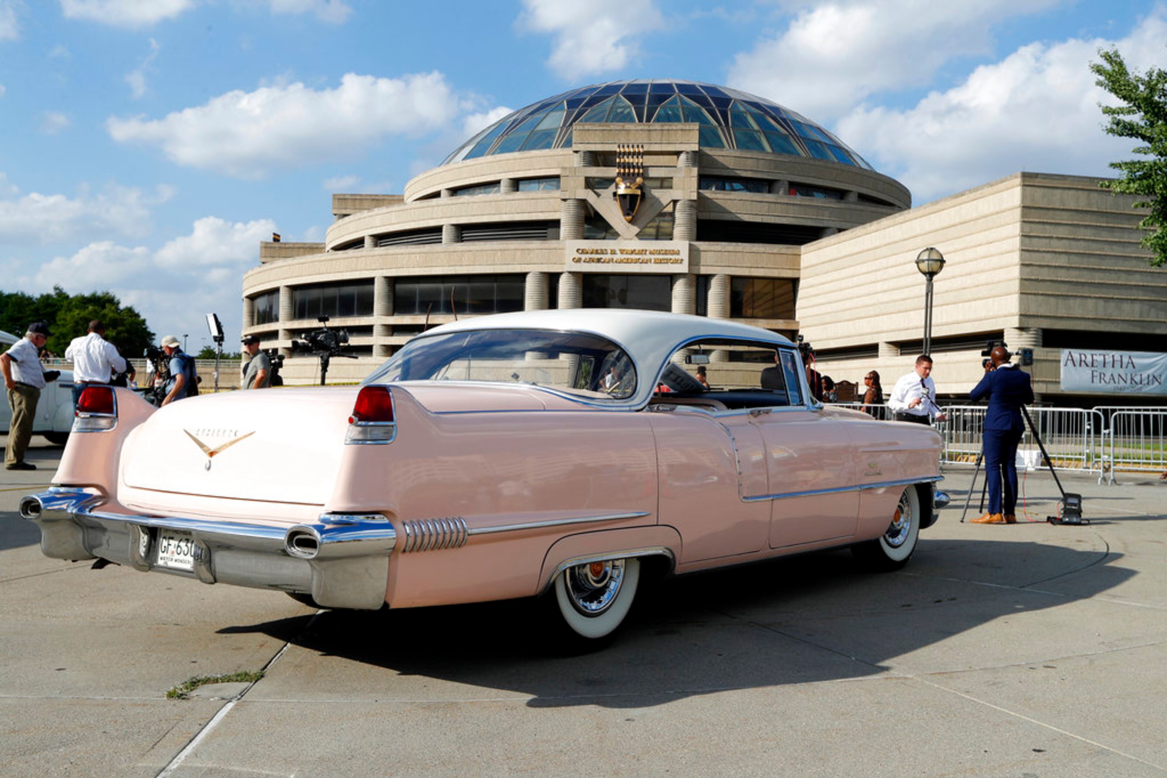A Pink Cadillac sits outside the Charles H. Wright Museum of African American History during a public visitation for legendary singer Aretha Franklin in Detroit, Tuesday, Aug. 28, 2018. Franklin died Aug. 16, 2018 of pancreatic cancer at the age of 76. (AP Photo/Paul Sancya)