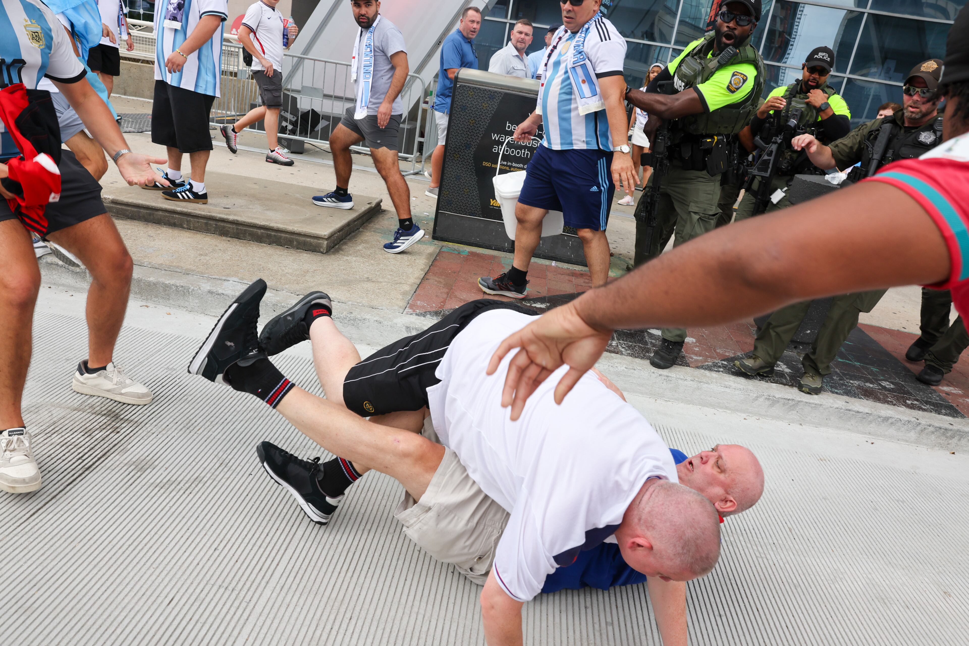England fans fall after being punched by Argentina fans after Argentina wins the FIFA World Cup game between England and Argentina in Atlanta on July 15, 2026. It’s the last game Atlanta is hosting. Argentina won 2-1. (Arvin Temkar/AJC)
