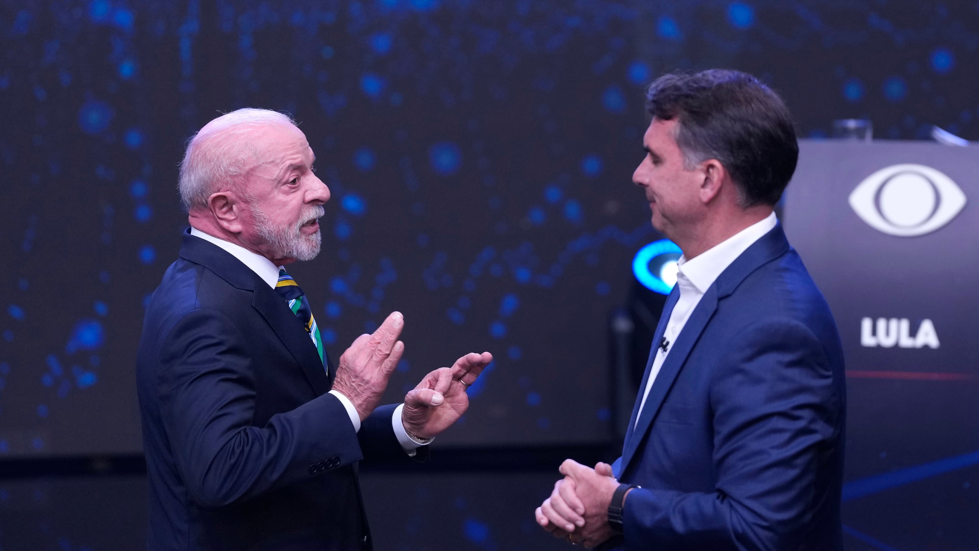 Brazilian President Luiz Inacio Lula da Silva, left, who is running for reelection, gestures as he speaks to opposition presidential candidate Sen. Flavio Bolsonaro during a televised presidential debate one week before the presidential runoff election in Sao Paulo, Brazil, Sunday, Oct. 18, 2026. (AP Photo/Andre Penner)