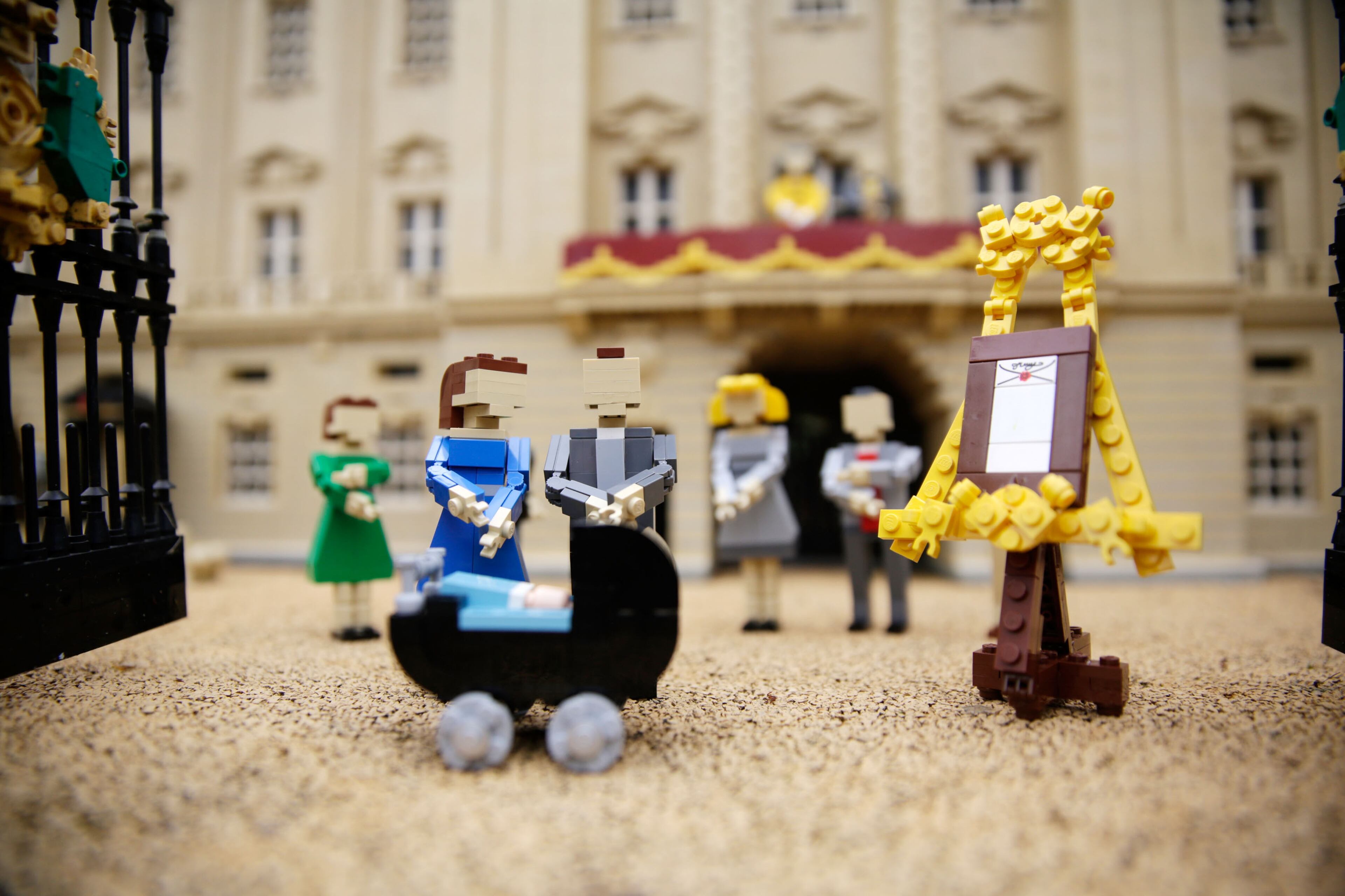 WINDSOR, ENGLAND - JULY 25: Lego models of the Duke and Duchess of Cambridge with their newborn son HRH Prince George of Cambridge outside a model of Buckingham Palace, part of a new attraction created to commemorate the birth of HRH Prince George of Cambridge at the Legoland resort on July 25, 2013 in Windsor, England. Model maker Katrina James constructed the baby and pram model out of 55 bricks, with the palace made out of 36,000 bricks. Catherine, Duchess of Cambridge gave birth to HRH Prince George of Cambridge at 16.24 BST on Monday July 22, 2013 with Prince William, Duke of Cambridge at her side. (Photo by Matthew Lloyd/Getty Images)