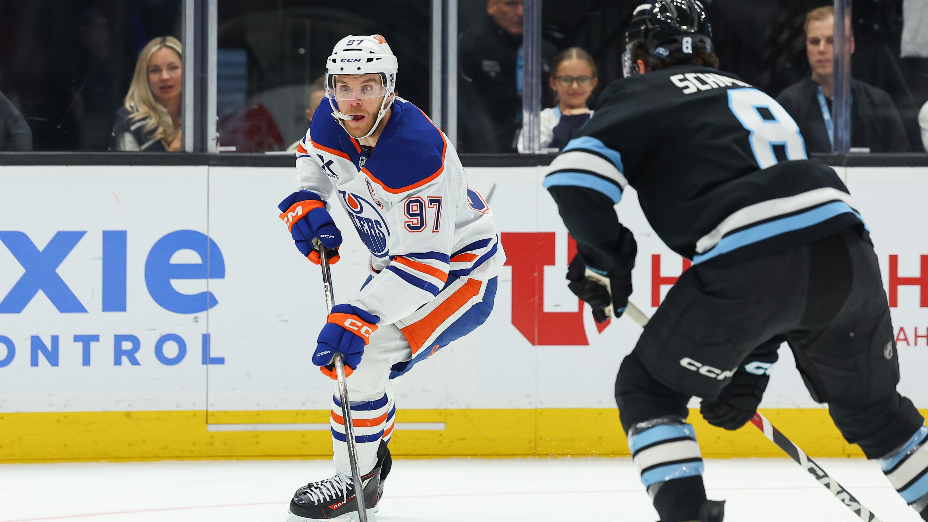 Edmonton Oilers center Connor McDavid (97) controls the puck against Utah Mammoth center Nick Schmaltz (8) during the first period of an NHL hockey game, Tuesday, March 24, 2026, in Salt Lake City. (AP Photo/Melissa Majchrzak)