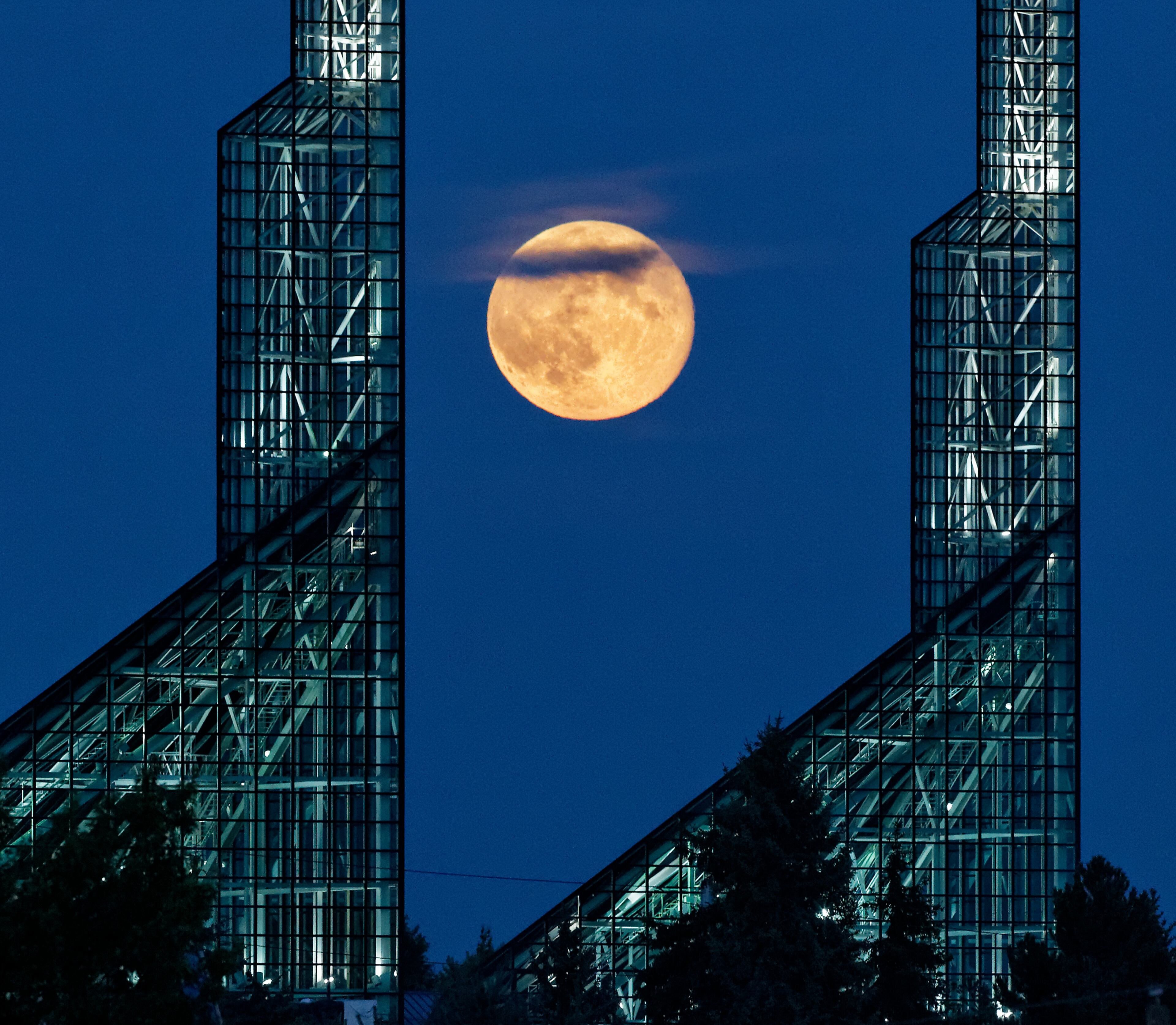 A supermoon rises over the Oregon Convention Center in Portland, Ore, Saturday, July 12, 2014. (AP Photo/The Oregonian, Mike Zacchino)