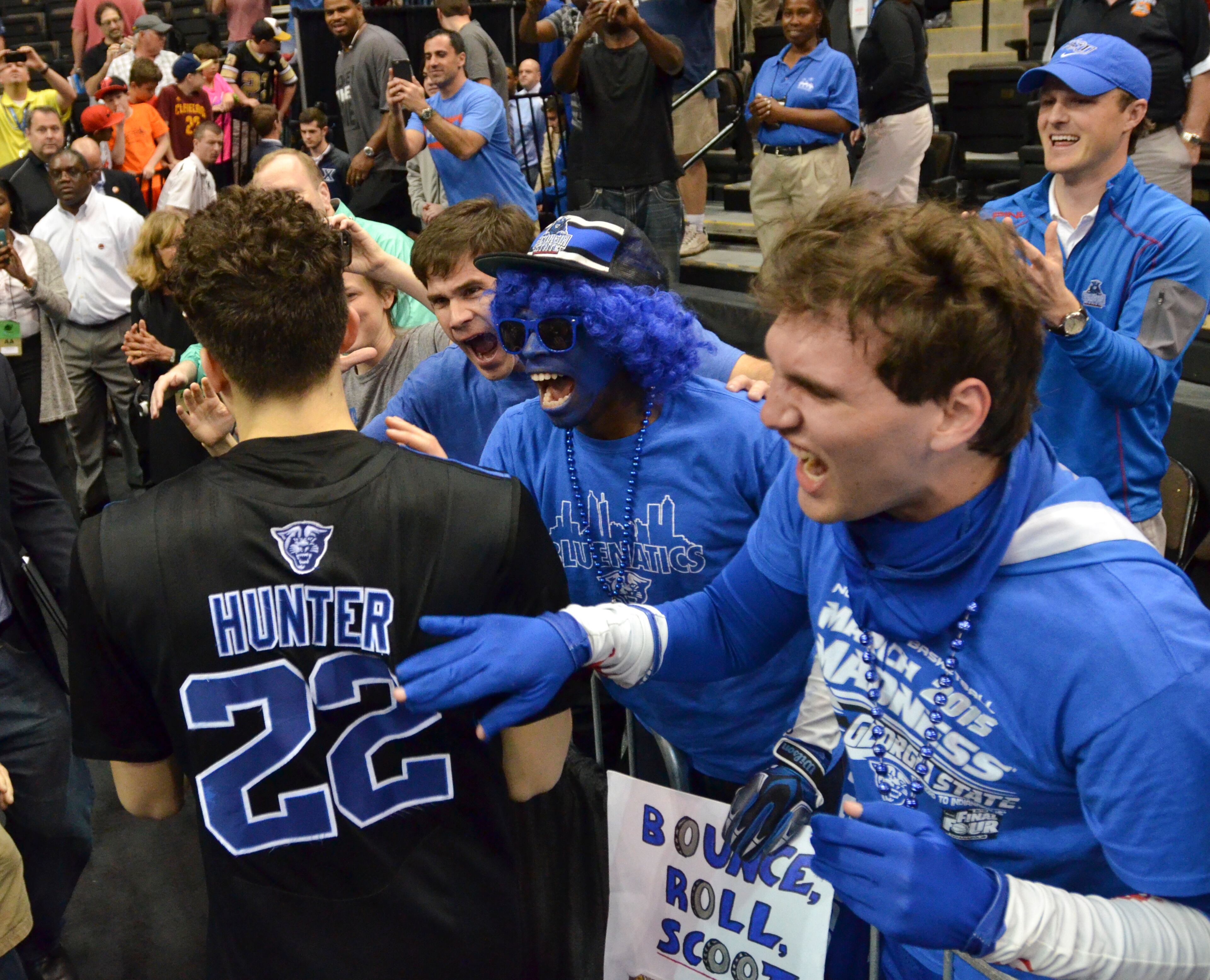 Georgia State's R.J. Hunter (22) celebrates with fans as he leaves the court after he made the game-winning shot against Baylor in the second round of the NCAA college basketball tournament, Thursday, March 19, 2015, in Jacksonville, Fla. Georgia State won 57-56. (AP Photo/Rick Wilson)