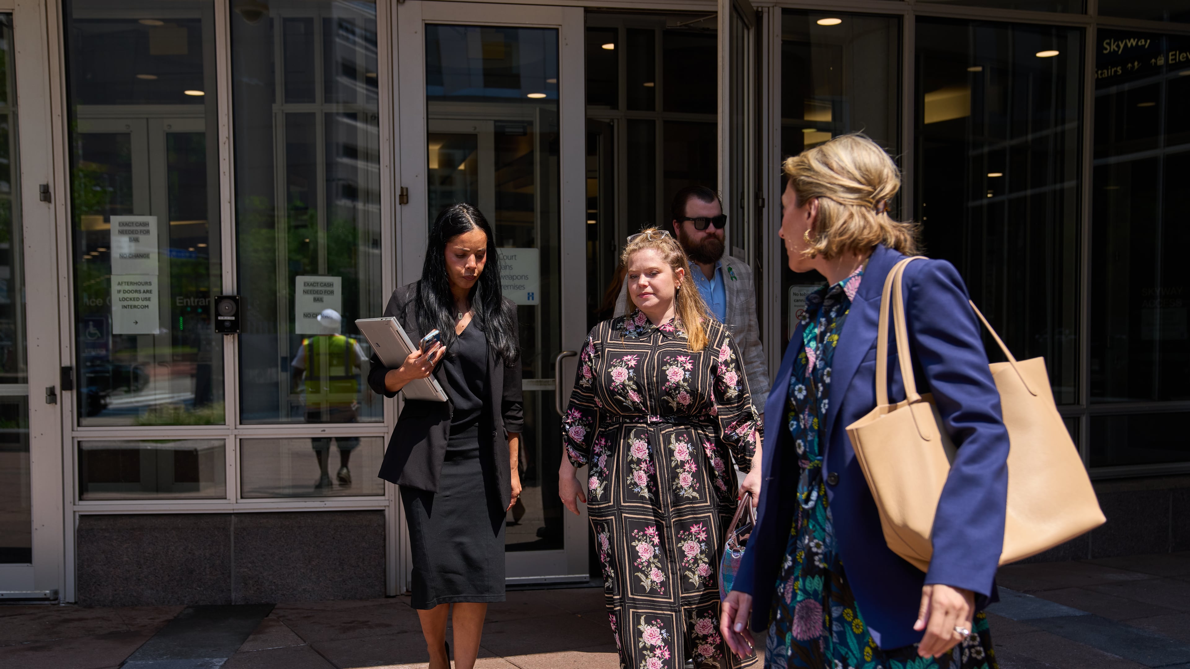 Colin Hortman, behind, son of Melissa and Mark Hortman, and his wife Alina Bachman Hortman, second from left, leave after attending the initial state court appearance for Vance Boelter, Monday, Aug. 3, 2026, in Minneapolis. (AP Photo/Ellen Schmidt)