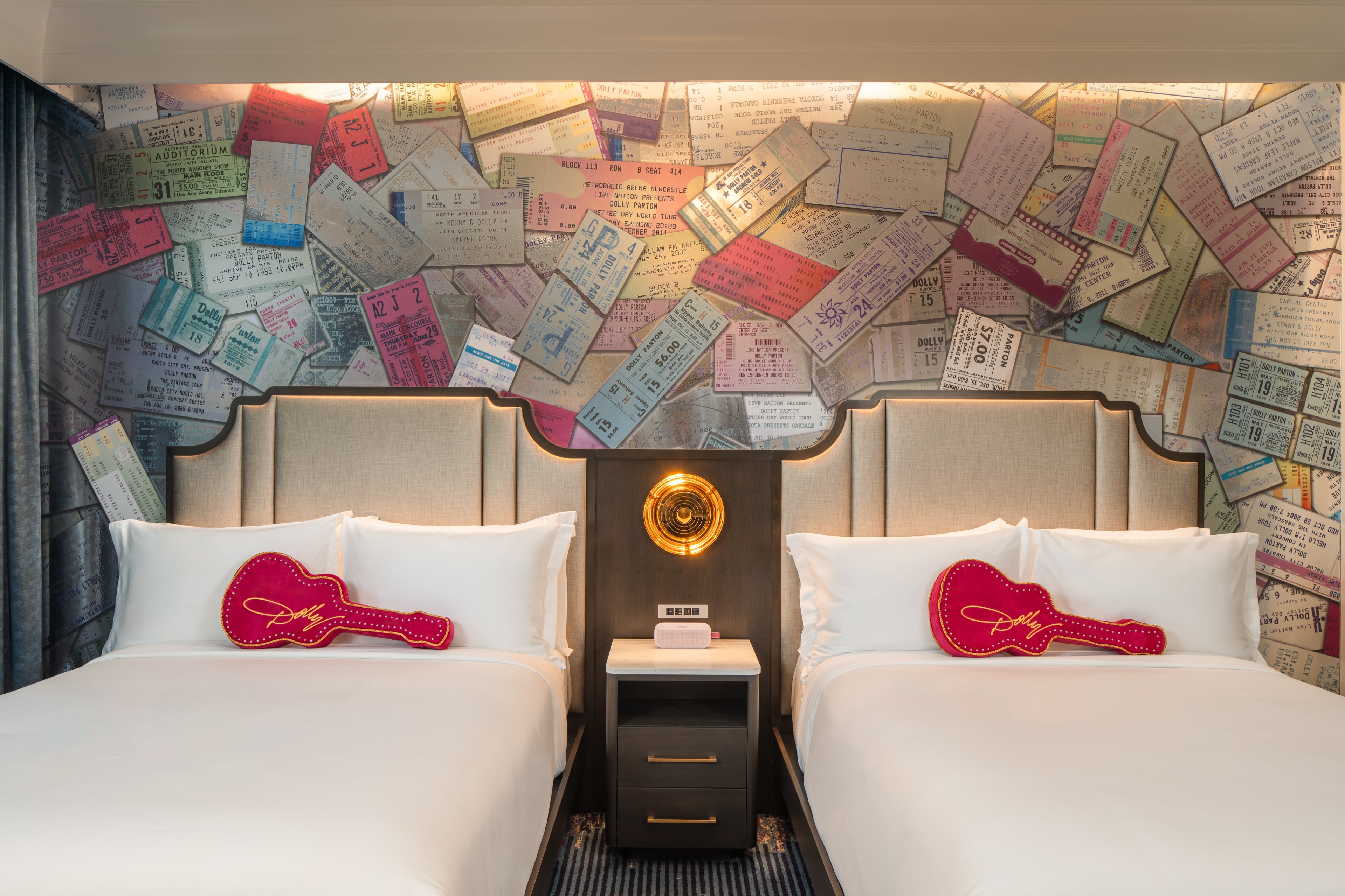A concert ticket design decorates the wallpaper in a guest room at a new Dolly Parton-themed hotel in Nashville,Tennessee, adding a musical touch to the accommodations inspired by the country music legend’s life and career. (Courtesy of Dolly Parton’s SongTeller Hotel)