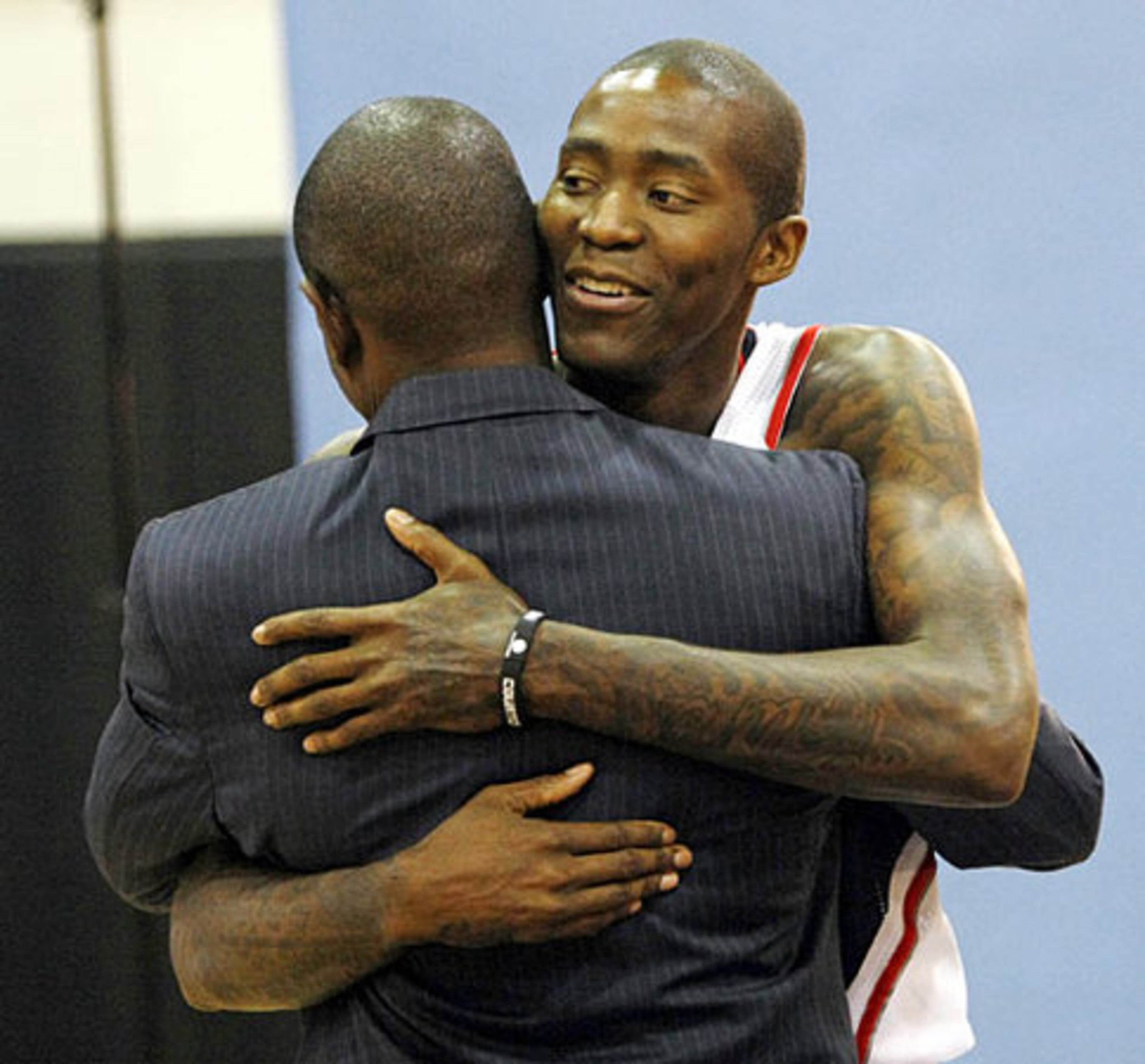 Jamal Crawford gives head coach Larry Drew a hug as Crawford arrives for pictures.