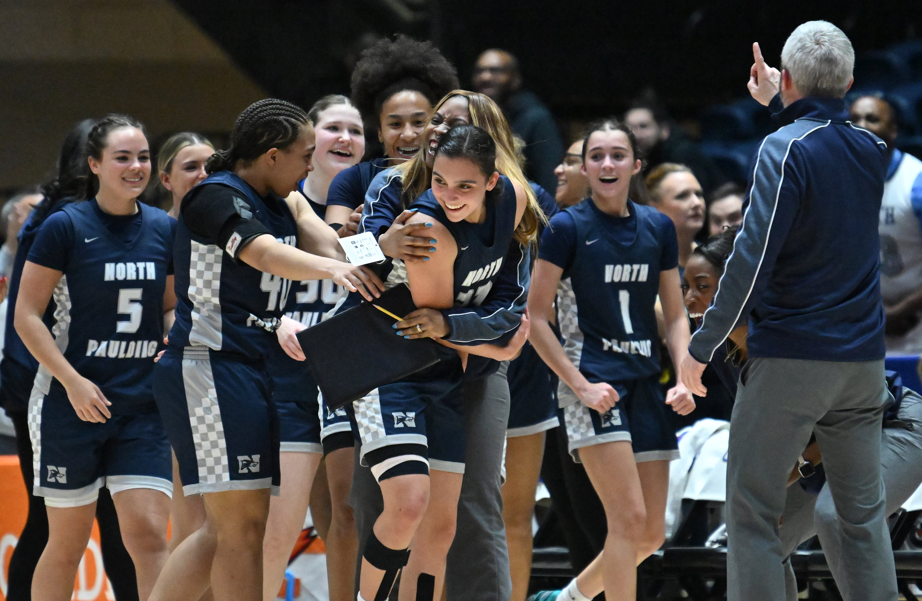 North Paulding Kalee Hinkson (23) is congratulated by teammates and teammates during the second half in Class 6A Girls GHSA State Championship at the Macon Coliseum, Saturday, March 14, 2026, in Macon. North Paulding won 64-58 over Grayson. (Hyosub Shin/AJC)