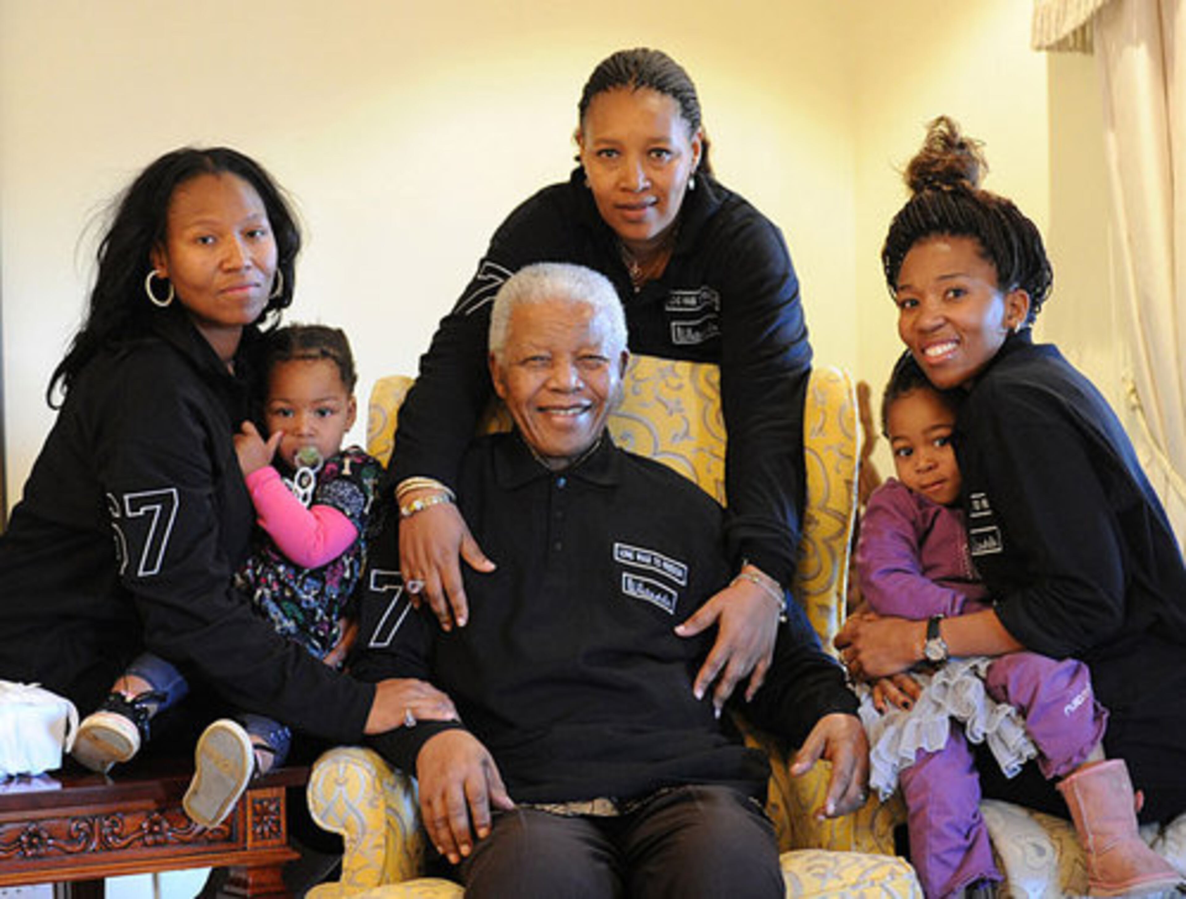 Former South Africa president Nelson Mandela, center, sits with family members, left to right, Zaziwe Manaway, Ziphokazi Manaway, Zamaswazi Dlamini and Zamak Obiri at Mandela's hometown in Qunu, South Africa, Sunday July 17, 2011. Center back is Mandela's daughter Princess Zenani Dlamini. Mandela celebrates his 93rd birthday Monday July 18, 2011.
