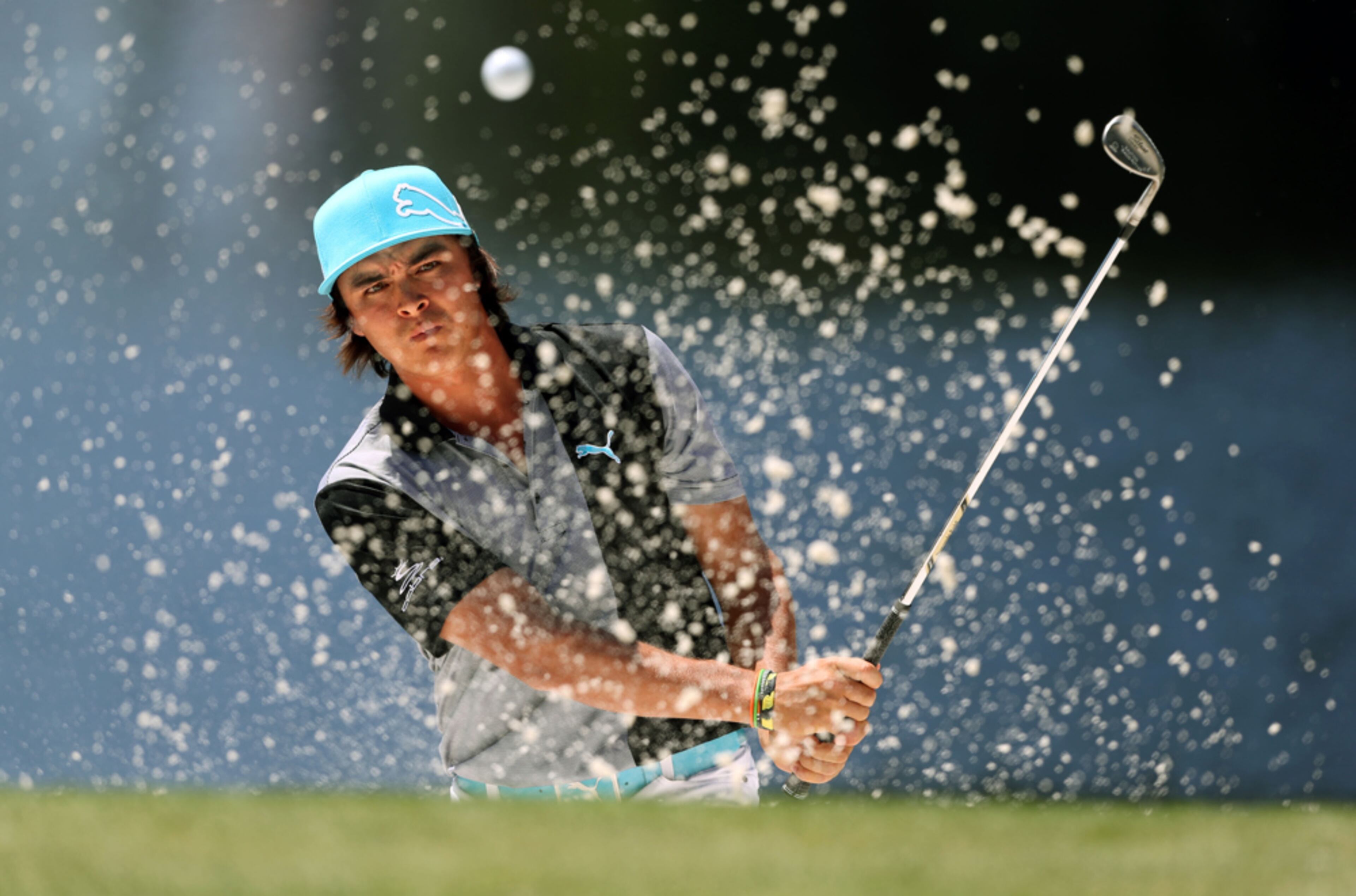 April 10, 2013 - Augusta, Ga: Rickie Fowler follows through on his bunker shot on the No. 4 green during the Par Three Contest the day before the 2013 Masters at Augusta National Golf Club Wednesday afternoon in Augusta, Ga., April 10, 2013. Getz said, "During the Par Three Contest, I placed myself on the No. 4 green for this photograph. Waiting for a golfer, like Fowler, to hit out of a bunker where the contract of the dark background and the white sand creates a clean and contrasting image." JASON GETZ / JGETZ@AJC.COM