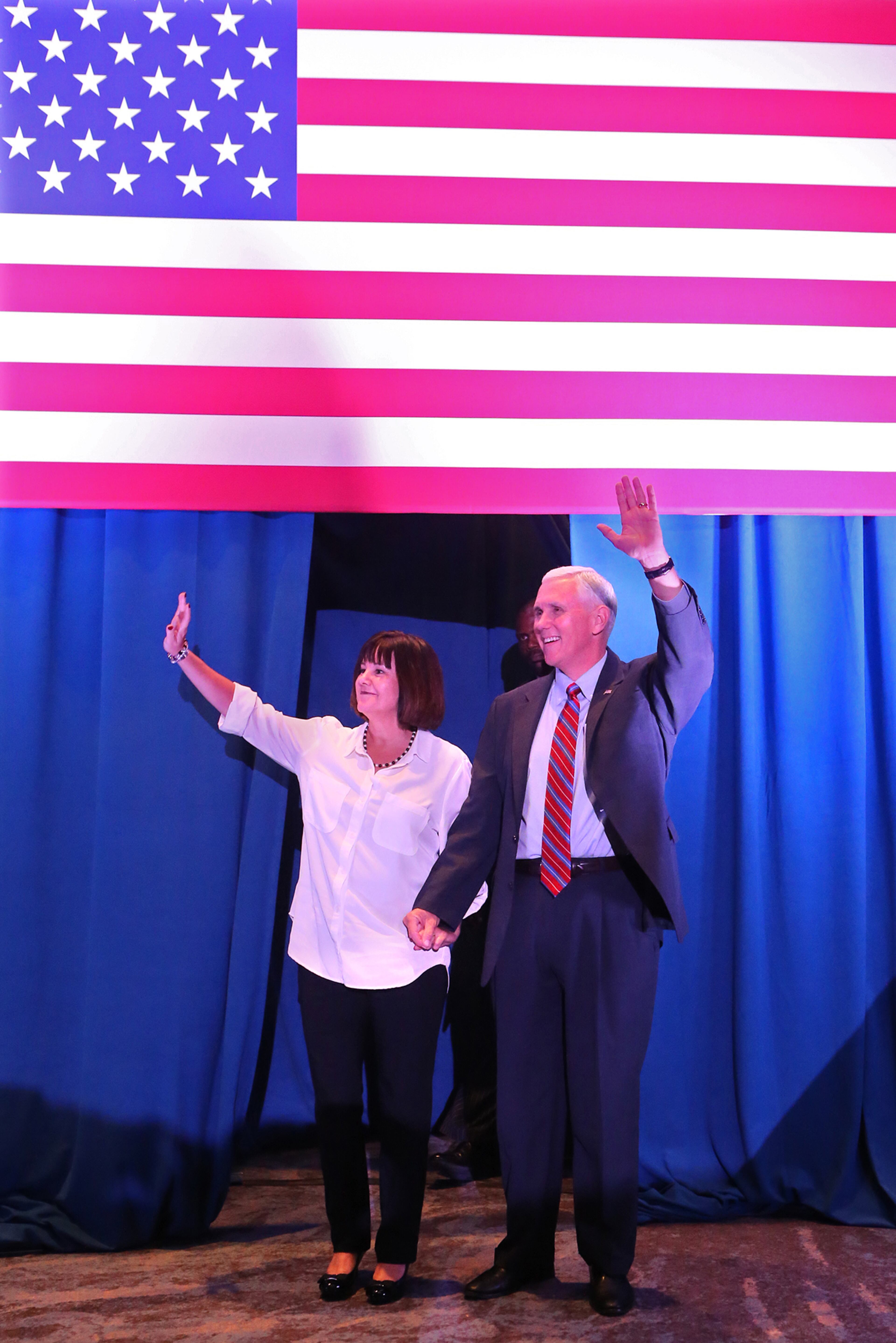 Pence and his wife Karen wave to supporters during a campaign stop on Monday, August 29, 2016, in Marietta. Curtis Compton /ccompton@ajc.com