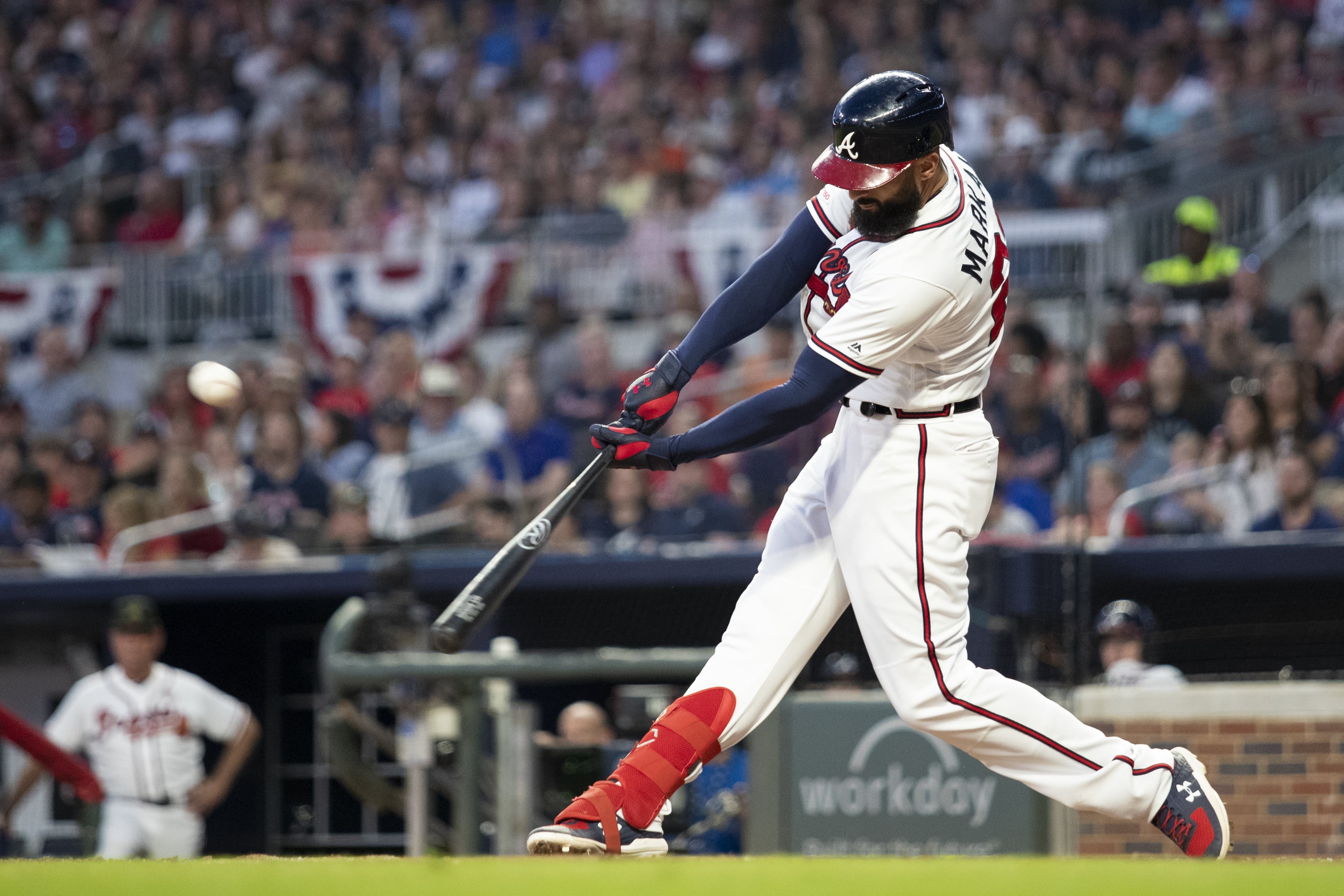 Nick Markakis #22 of the Atlanta Braves hits a sacrifice fly in the third inning during the game against the Milwaukee Brewers at SunTrust Park on May 18, 2019 in Atlanta, Georgia. (Photo by Carmen Mandato/Getty Images)