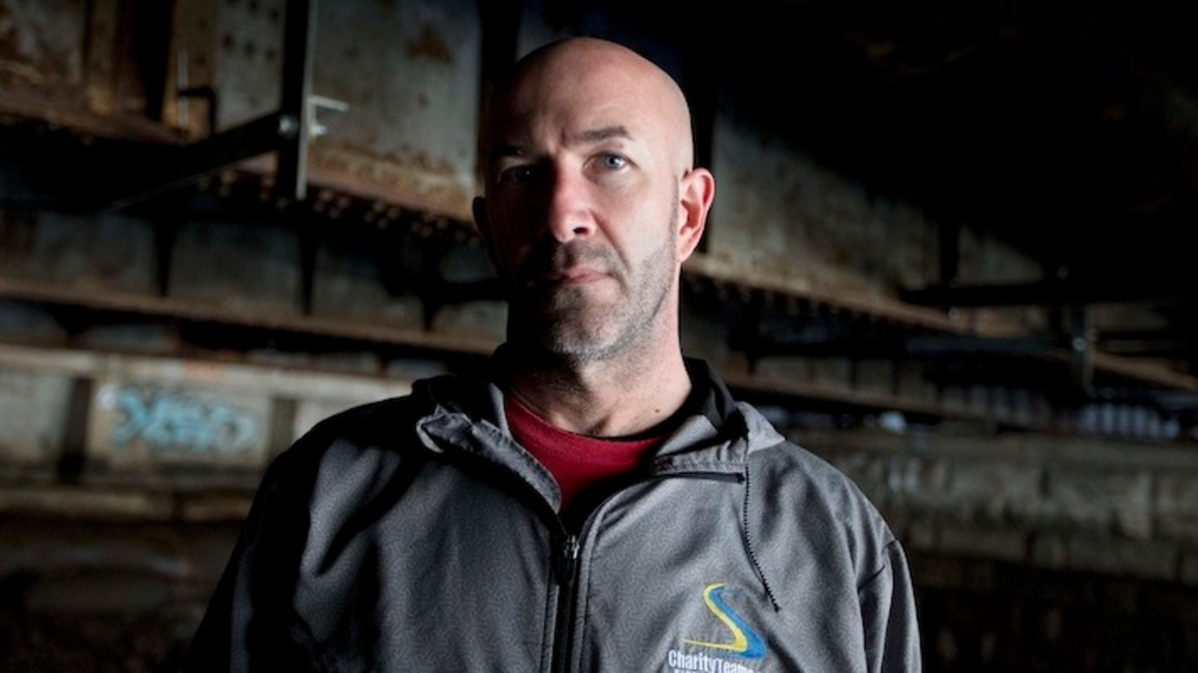 In this March 18, 2017 photo, Danny Dwyer poses under the bridge where he used to sleep during when he was homeless in Boston. Dwyer, 50, plans to run in the April 17, Boston Marathon. It's the latest step away from his former battles with drug addiction, job loss and four years living under the bridge. (AP Photo/Michael Dwyer)